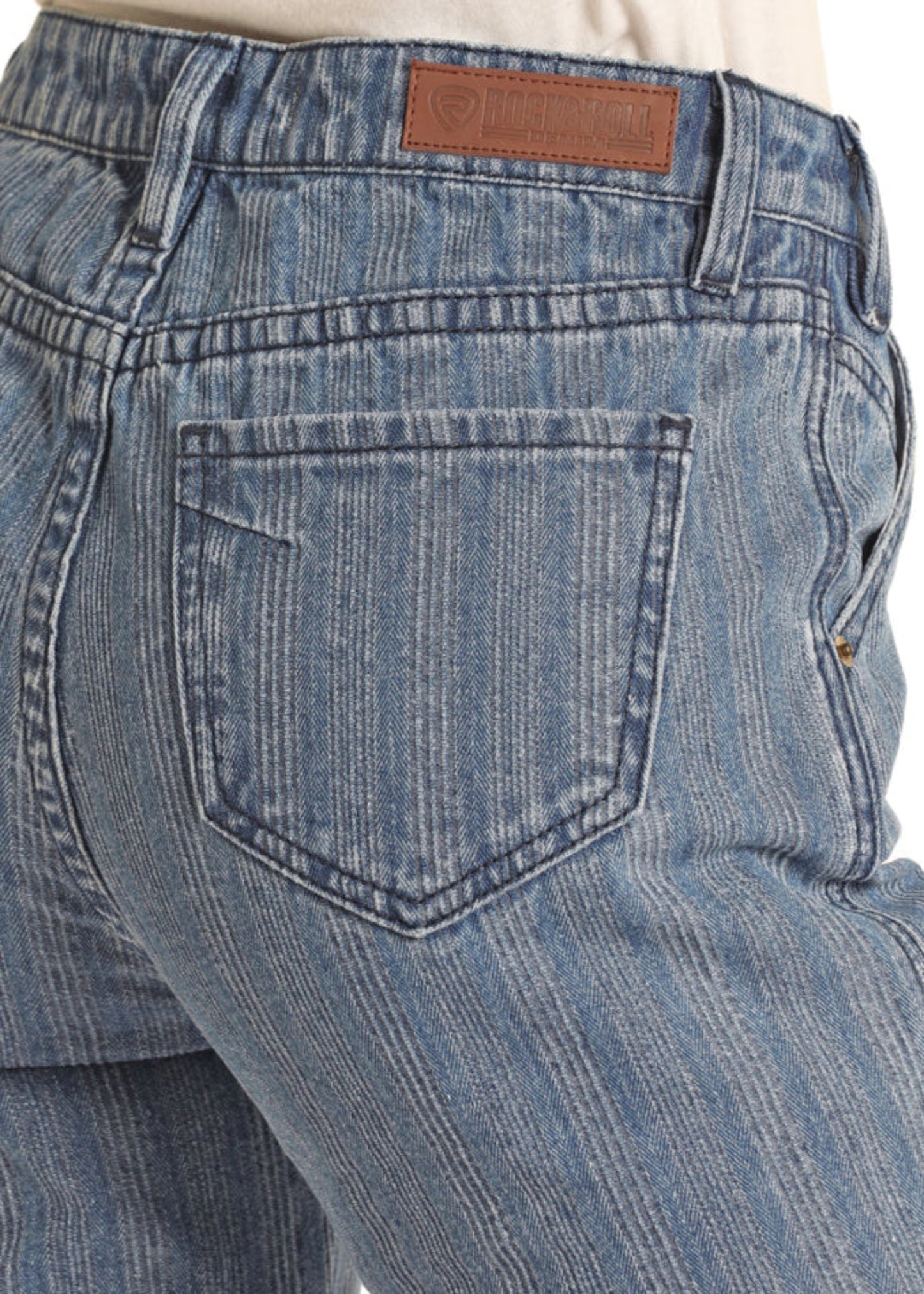 Blue jeans with a brand label on the back pocket against a white background