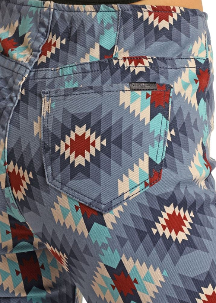 Person wearing blue patterned pants with a white background