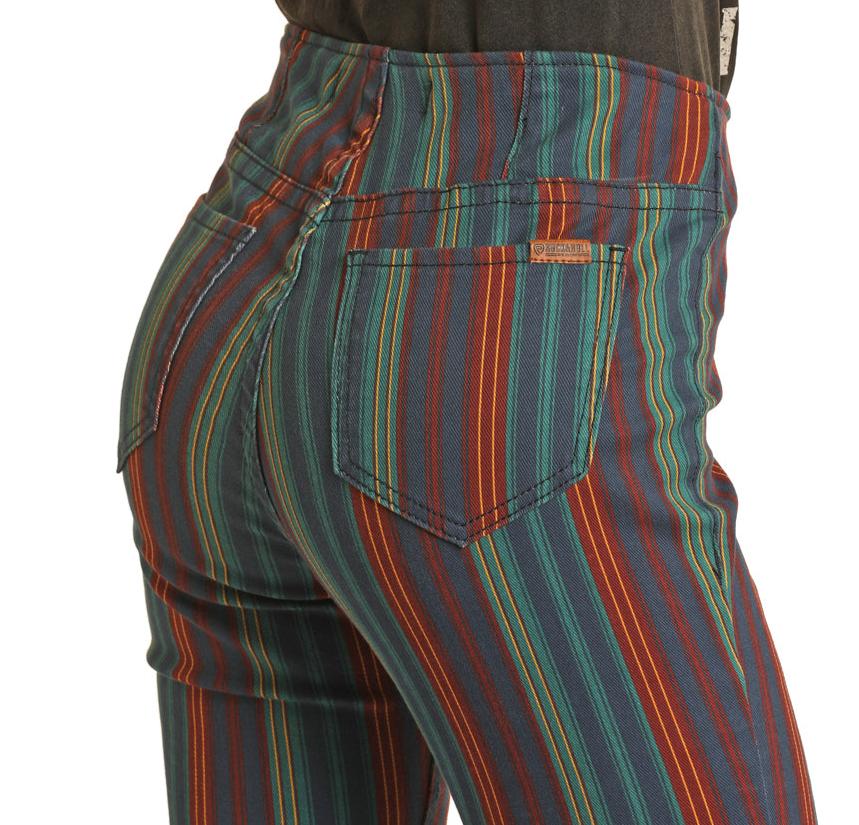 Close-up of a person wearing Rock & Roll Denim's Mid Rise Striped Pull-On Jeans, featuring teal, red, orange, and yellow vertical stripes, back pockets, and visible stitching for western flair.