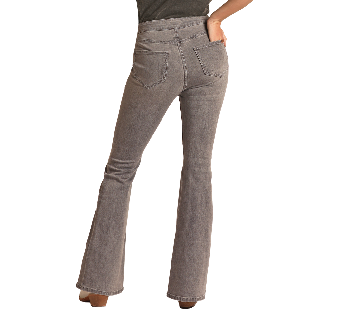 A person stands with one hand on their hip, shown from the back against a plain white background, wearing Rock & Roll Denim’s Grey Wash High Rise Flare Jeans and a dark top, exuding subtle western sophistication.