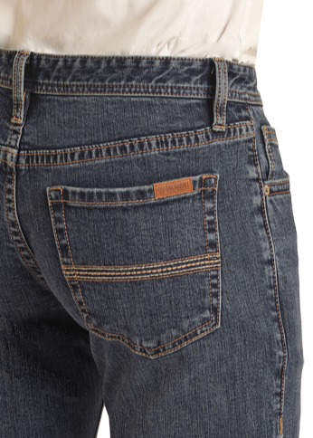 A person shown from the back wears Rock & Roll Denim's Vintage '46 Slim Straight Leg Jeans, with dark blue wash, bold orange stitching, large back pockets, and a subtle two-tone pocket stitch for a retro look.