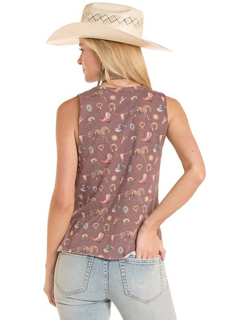 Woman wearing a sleeveless patterned top and light blue jeans on a white background