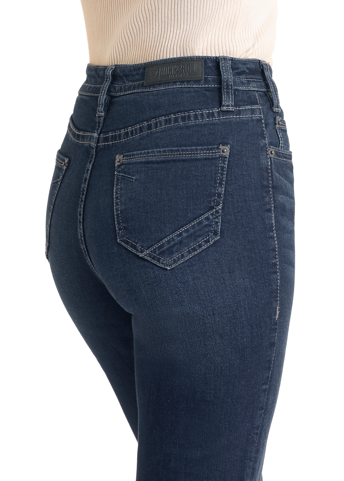 A person wearing Rock & Roll Denim Button Fly High Rise Trousers, shown from the side and back waist down, highlights the slim fit, button fly closure, and stitching details of these dark blue jeans.