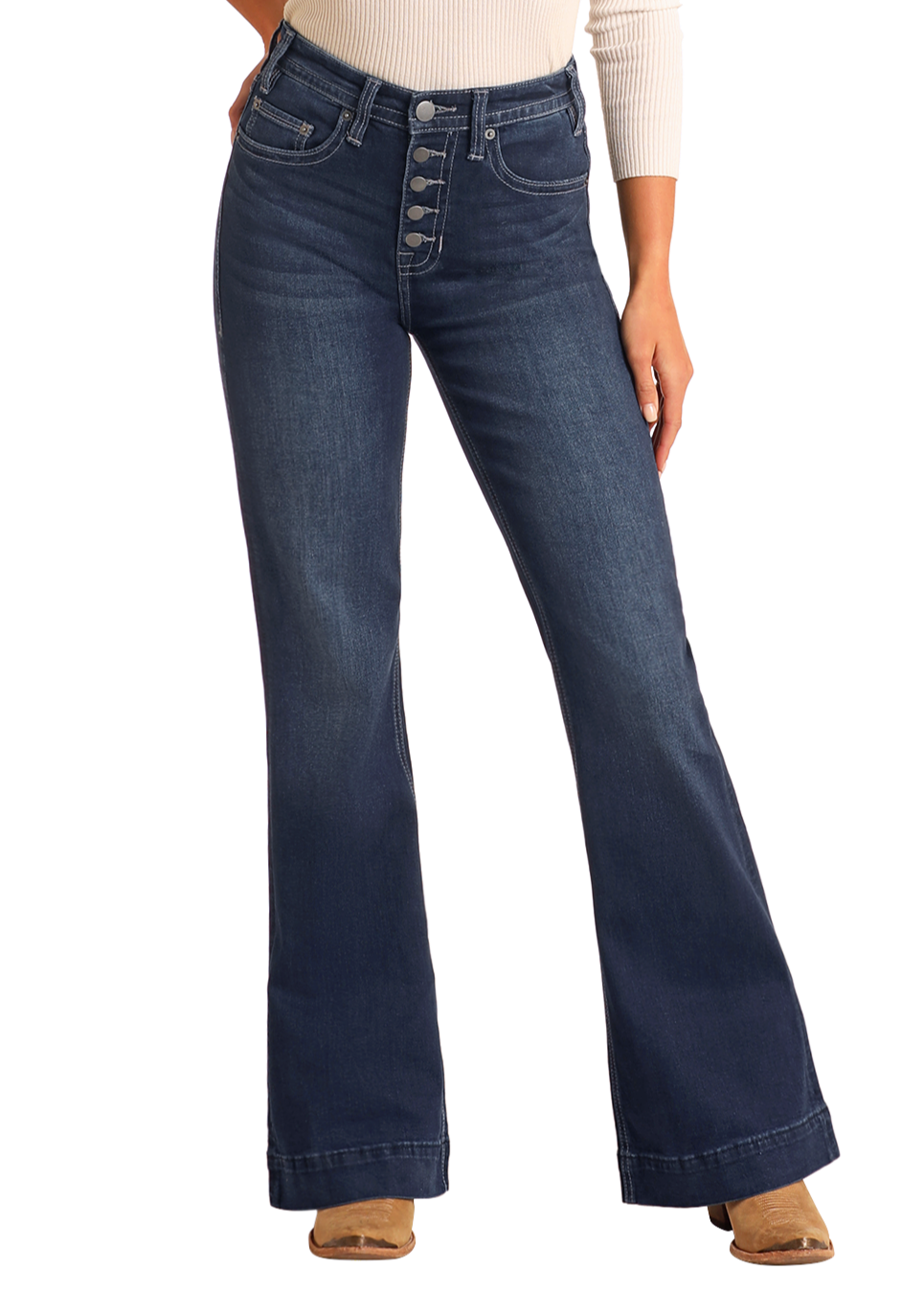 A person wears Rock & Roll Denim Button Fly High Rise Trousers, a beige long-sleeve top, and tan shoes, standing against a plain light background.