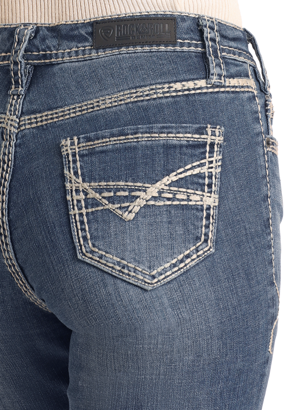 Close-up of a person wearing Rock & Roll Denim's Mid Rise Petal Stitch Trousers, featuring white double-stitching on the back pockets and waistband, a black leather brand patch, and a light ribbed top tucked in.