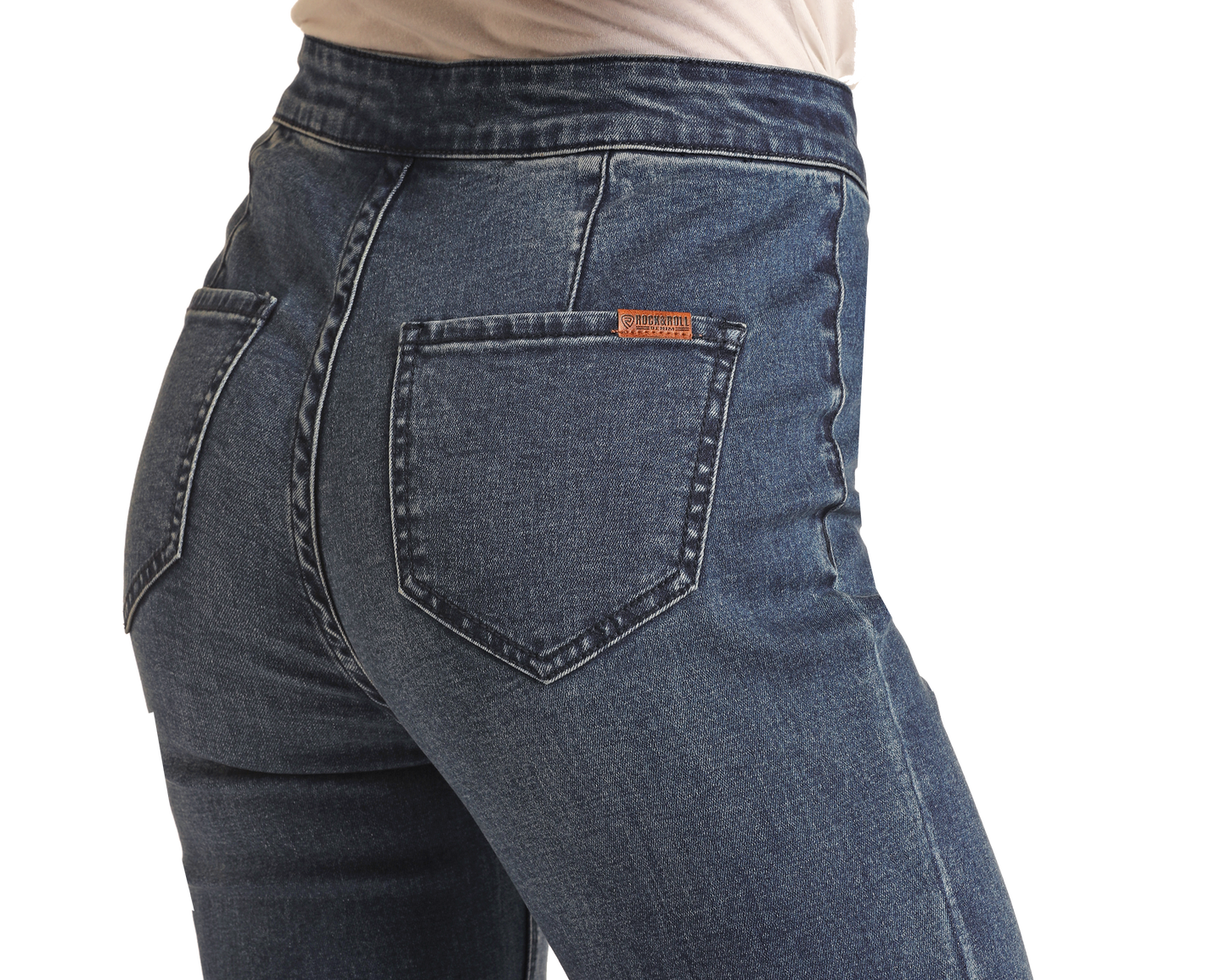 A close-up shows a person wearing Rock & Roll Denim Dark Wash High Rise Bell Bottoms with visible back pockets and a small brown leather patch on the right pocket, set against a plain white background.
