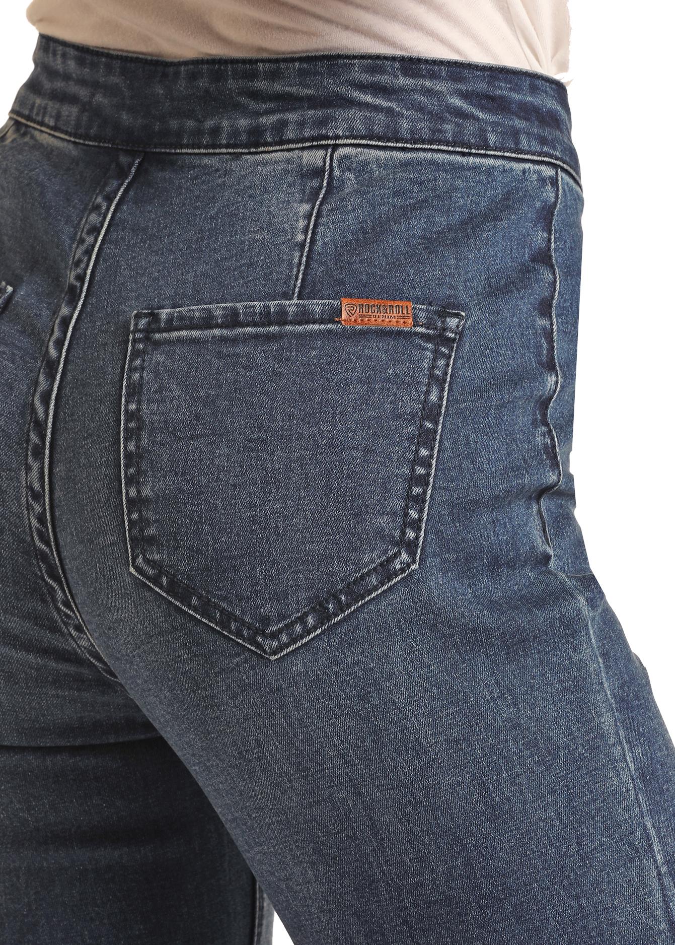 A close-up shows a person wearing Rock & Roll Denim Dark Wash High Rise Bell Bottoms with visible back pockets and a small brown leather patch on the right pocket, set against a plain white background.