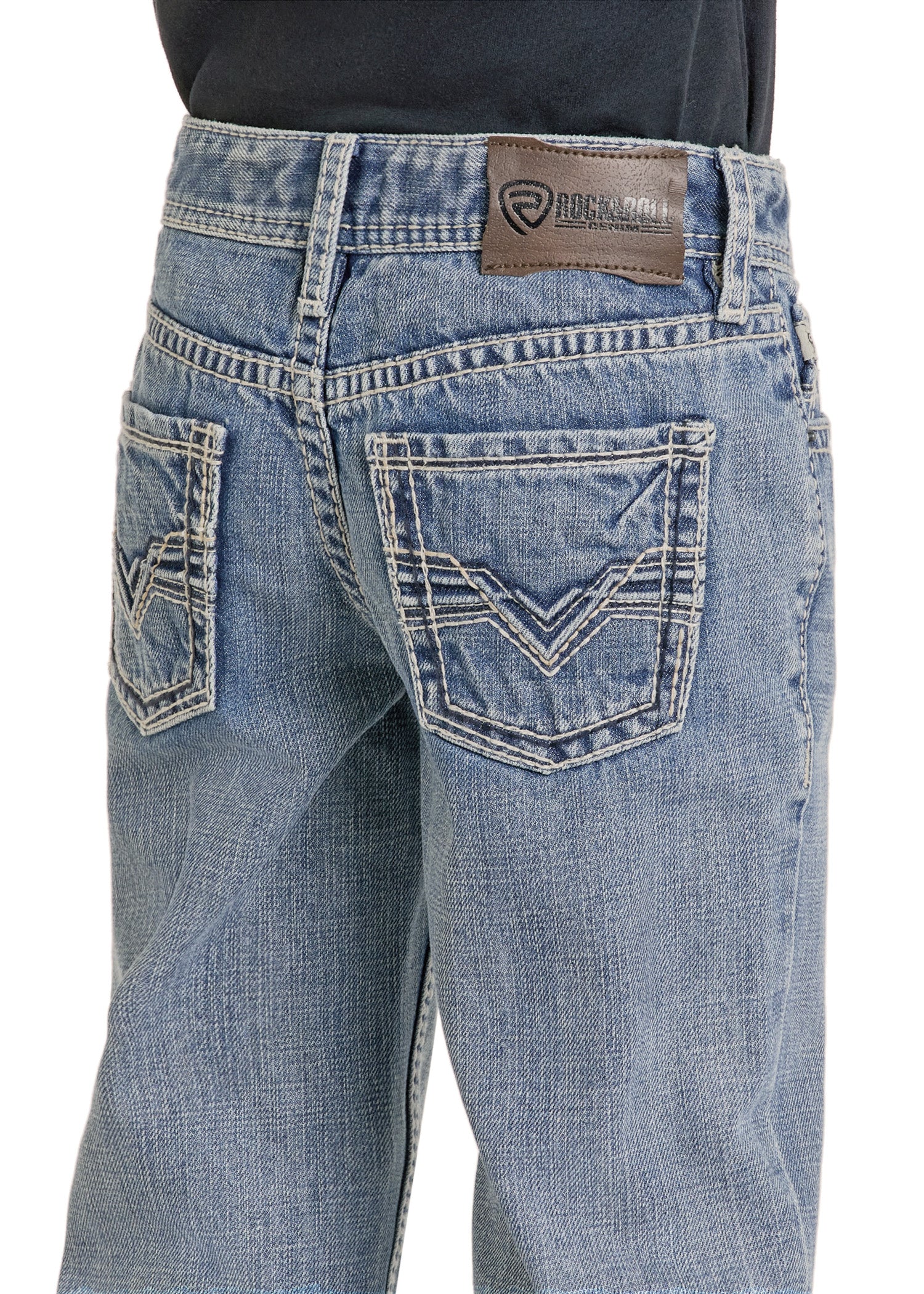 A close-up of the back of a person wearing Rock & Roll Denim Boys' Regular Fit Raised Signature Bootcut Jeans in light blue, featuring decorative stitching on the back pockets and a brown leather brand patch on the waistband.