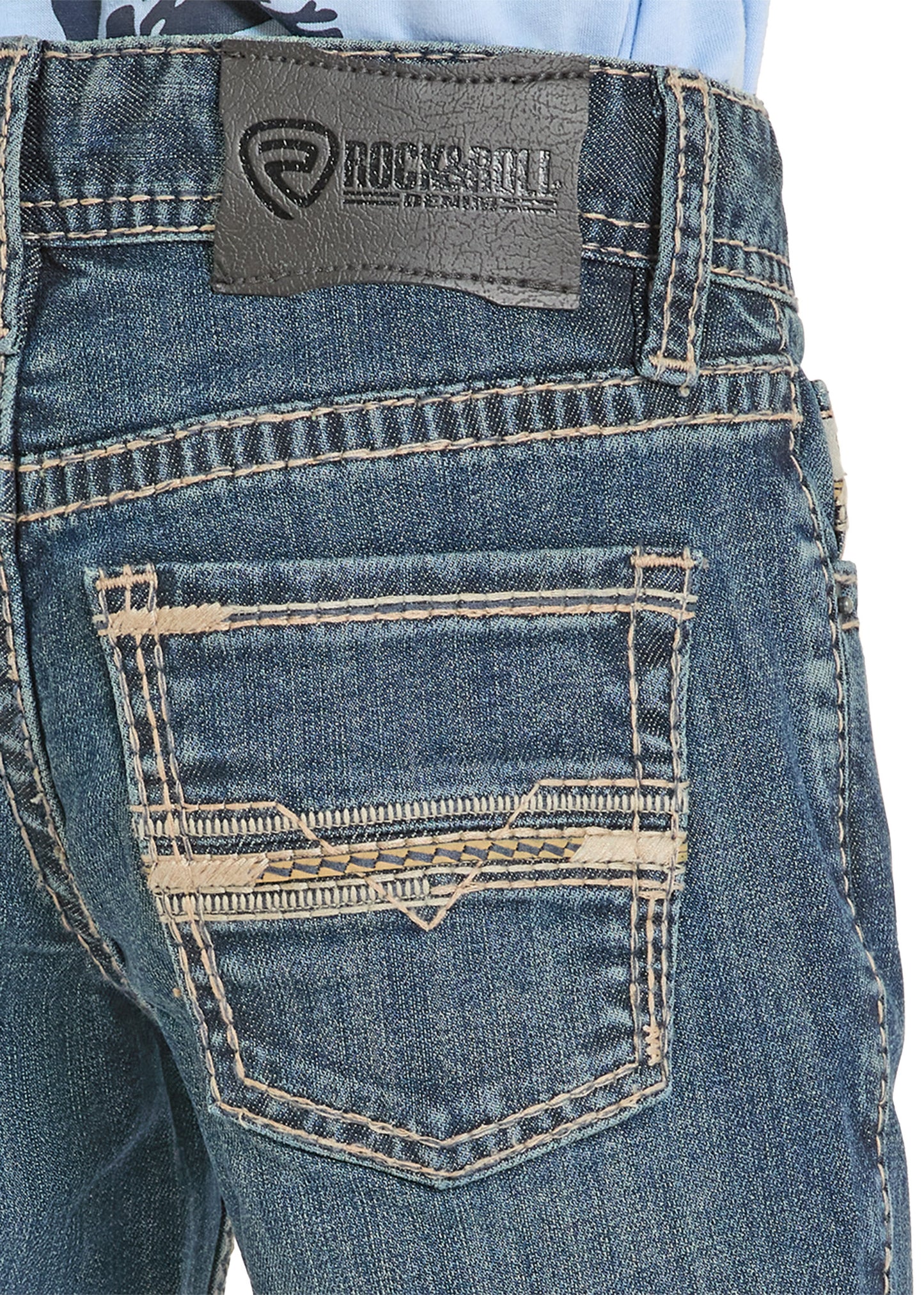 Close-up of blue jeans with a visible brand label on a white background