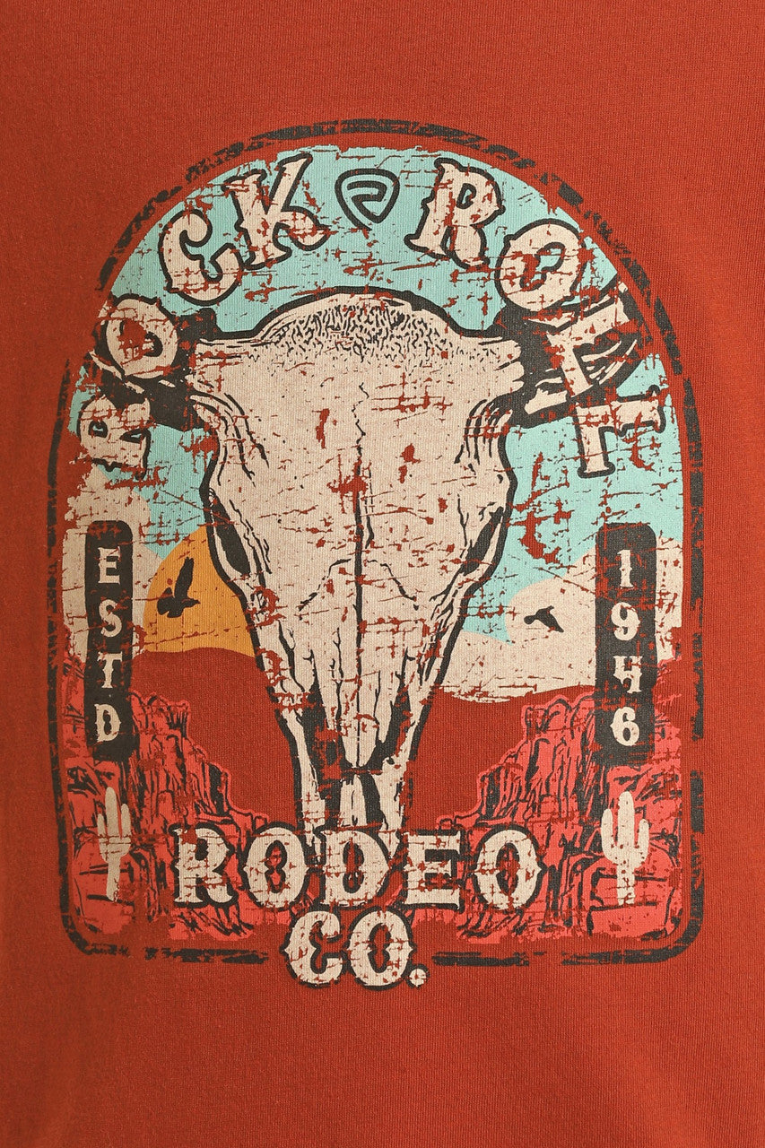 The Boys' Desert Skull T-Shirt by Rock & Roll Denim features a vintage-style bull skull, desert scene, cacti, and “Rock & Roll Rodeo Co. ESTD 1946” text on a faded red background for a classic look.