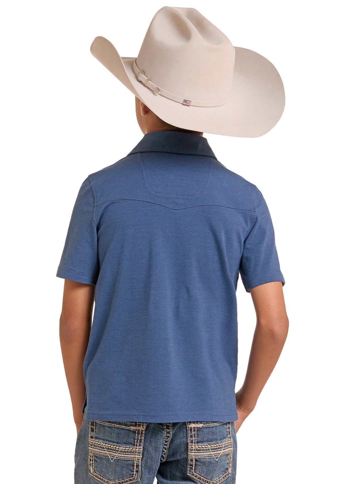 A child shown from the back wearing a blue short-sleeve western-style polo shirt, blue jeans, and a light beige cowboy hat against a plain white background.