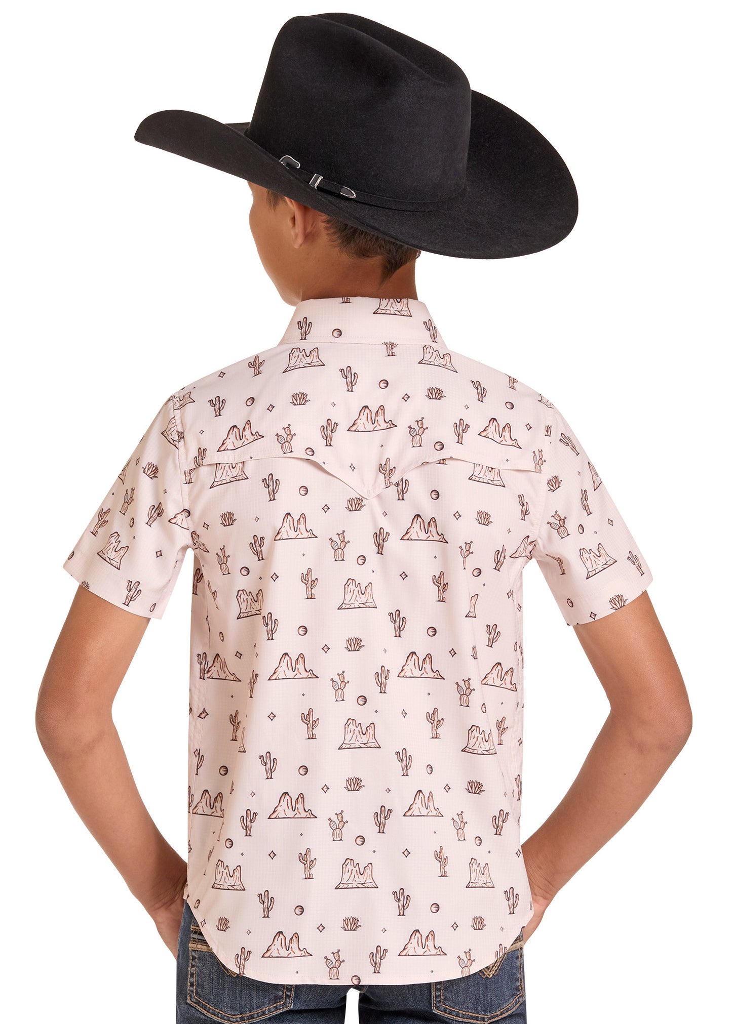 A child wearing a black cowboy hat, a light pink western-style short-sleeve button-up shirt with a brown desert pattern, and blue jeans, shown from the back against a white background.