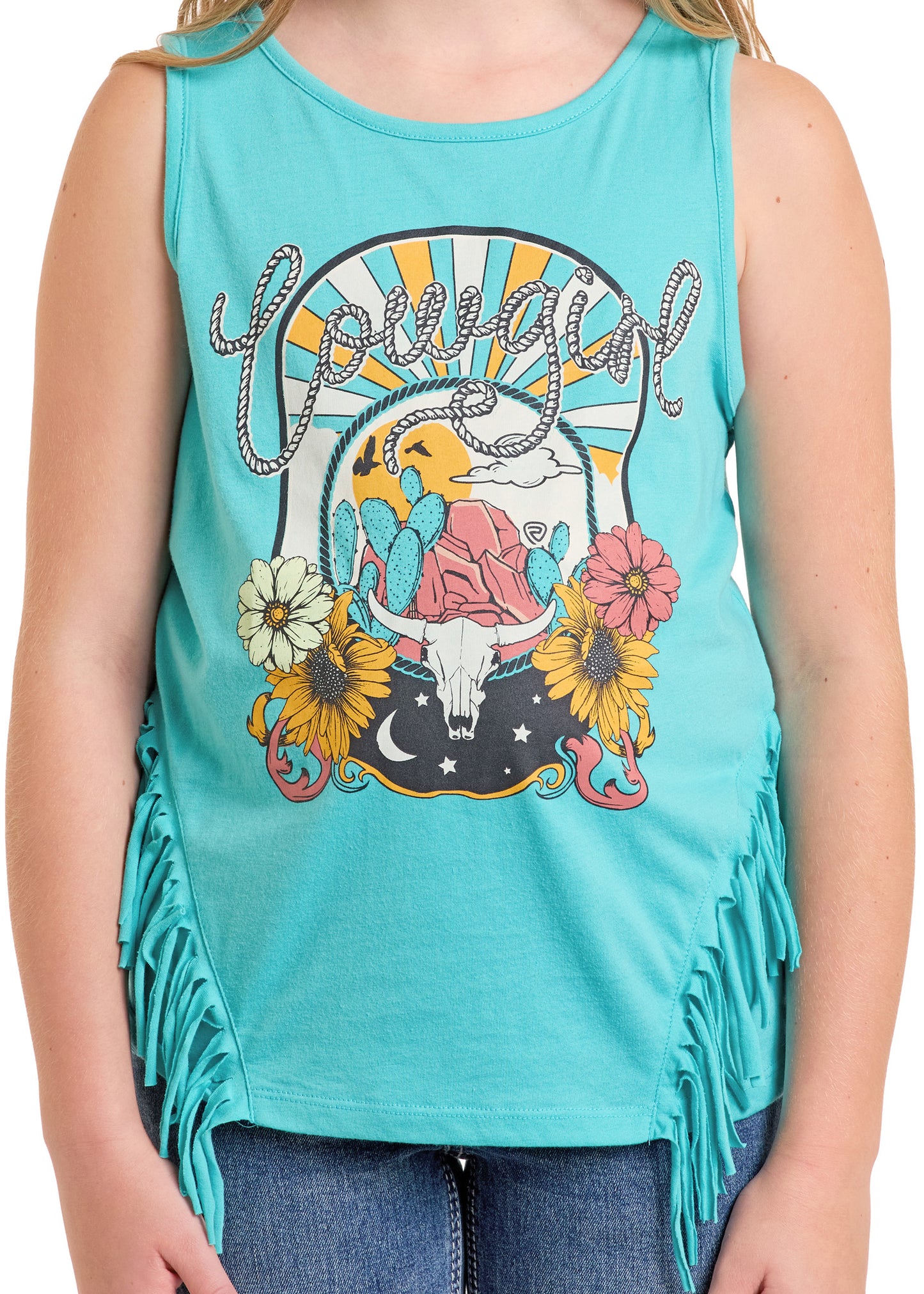 A girl rocks the Rock & Roll Denim Girls' Cowgirl Fringe Tank featuring "Cowgirl," a cow skull, sun, moon, flowers, and side fringe—perfect with blue jeans for western adventures.