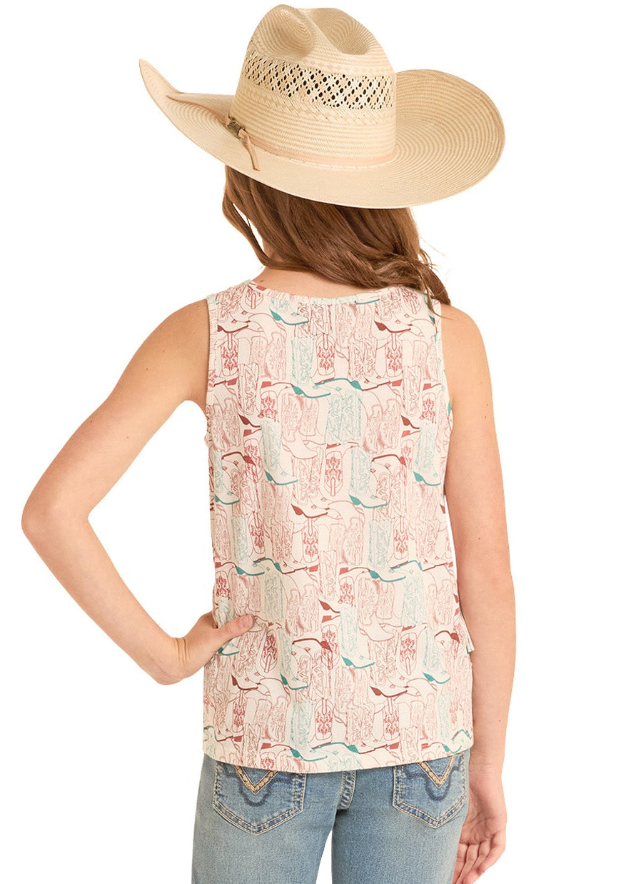 Person wearing a sleeveless top with a floral pattern and jeans on a white background