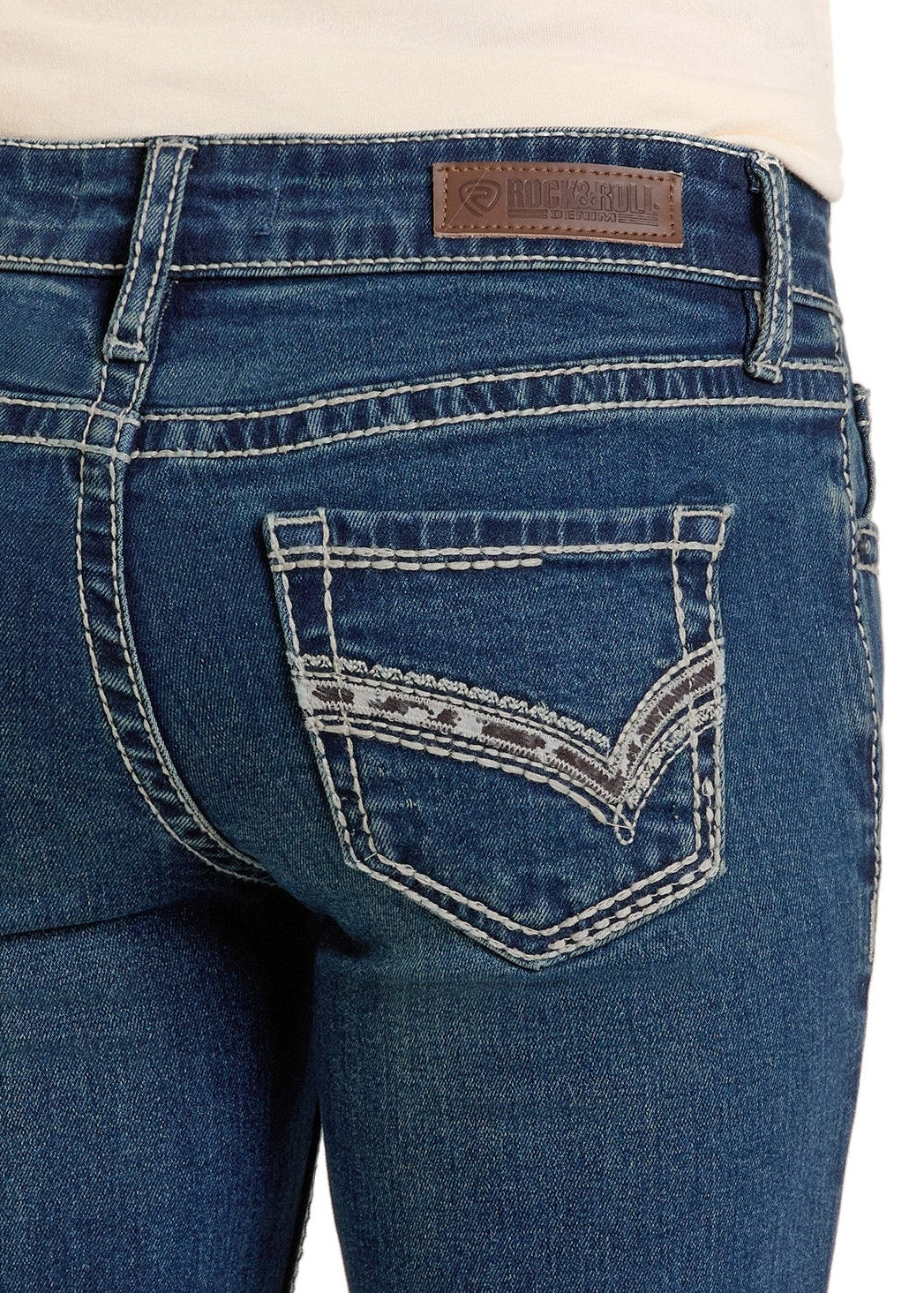 Close-up of Western jeans with white stitching and a patterned, embroidered cowhide back pocket. A brown leather "Rock & Roll Denim" patch accents the waistband of these stylish Girls' Cowhide Pocket Bootcut Jeans - 8.