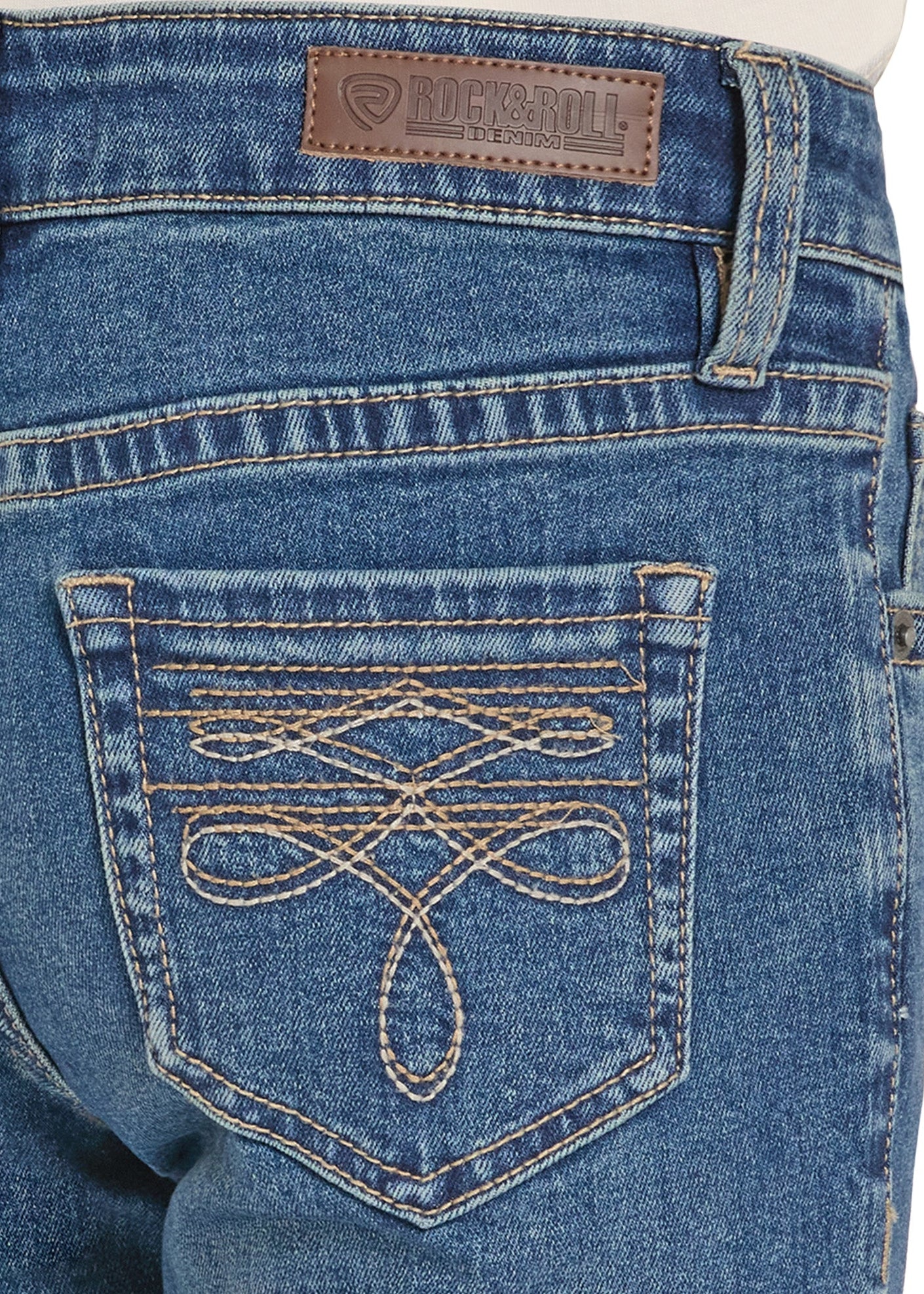 Close-up of blue jeans with a brand label on the back pocket.