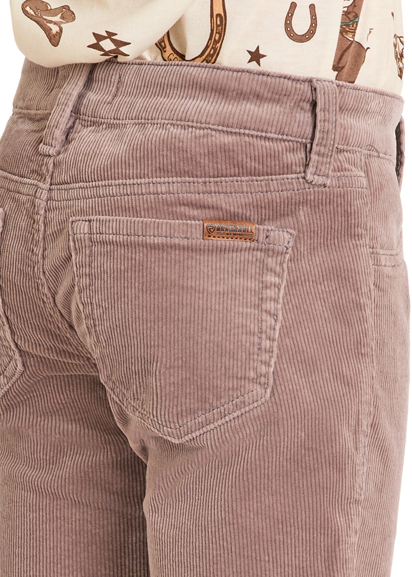 Close-up of brown corduroy pants with a brand label.