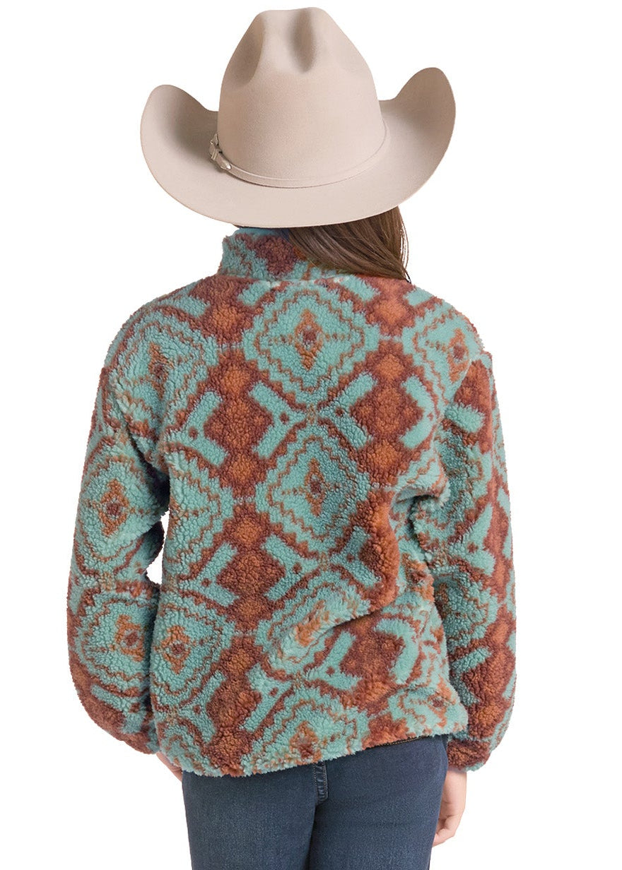 A woman viewed from behind wearing a patterned sherpa fleece jacket, blue jeans, and a beige cowboy hat against a white background.