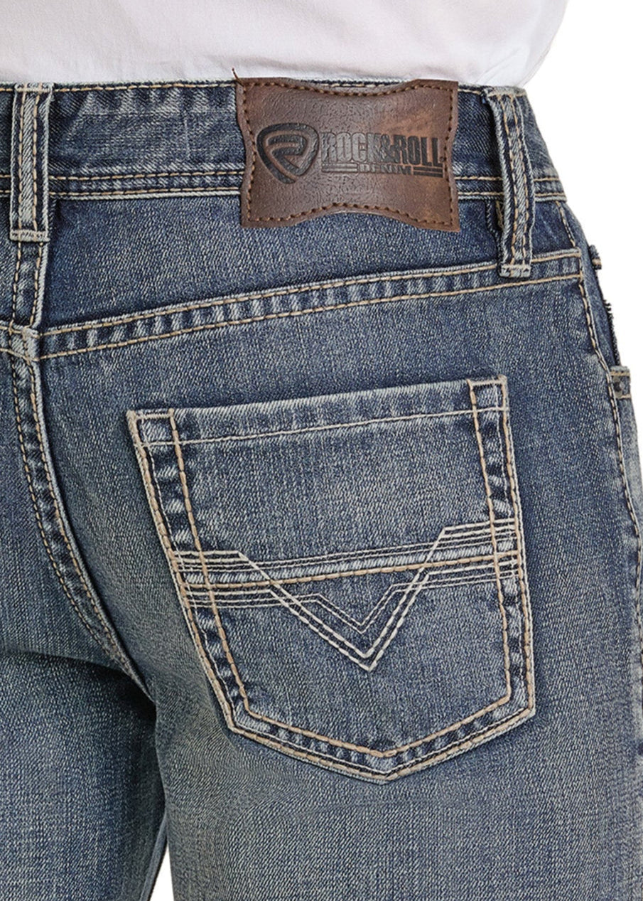 Close-up of the back of a person wearing Rock & Roll Denim Relaxed Fit Medium Tone Bootcut Jeans, featuring detailed pocket stitching and a brown leather brand label.