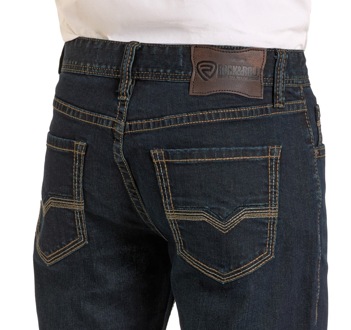 Close-up of a person wearing Rock & Roll Denim's Relaxed Fit Flat Seam Pocket Straight Leg Jeans with contrasting stitching and a leather waistband patch, paired with a white shirt tucked in.