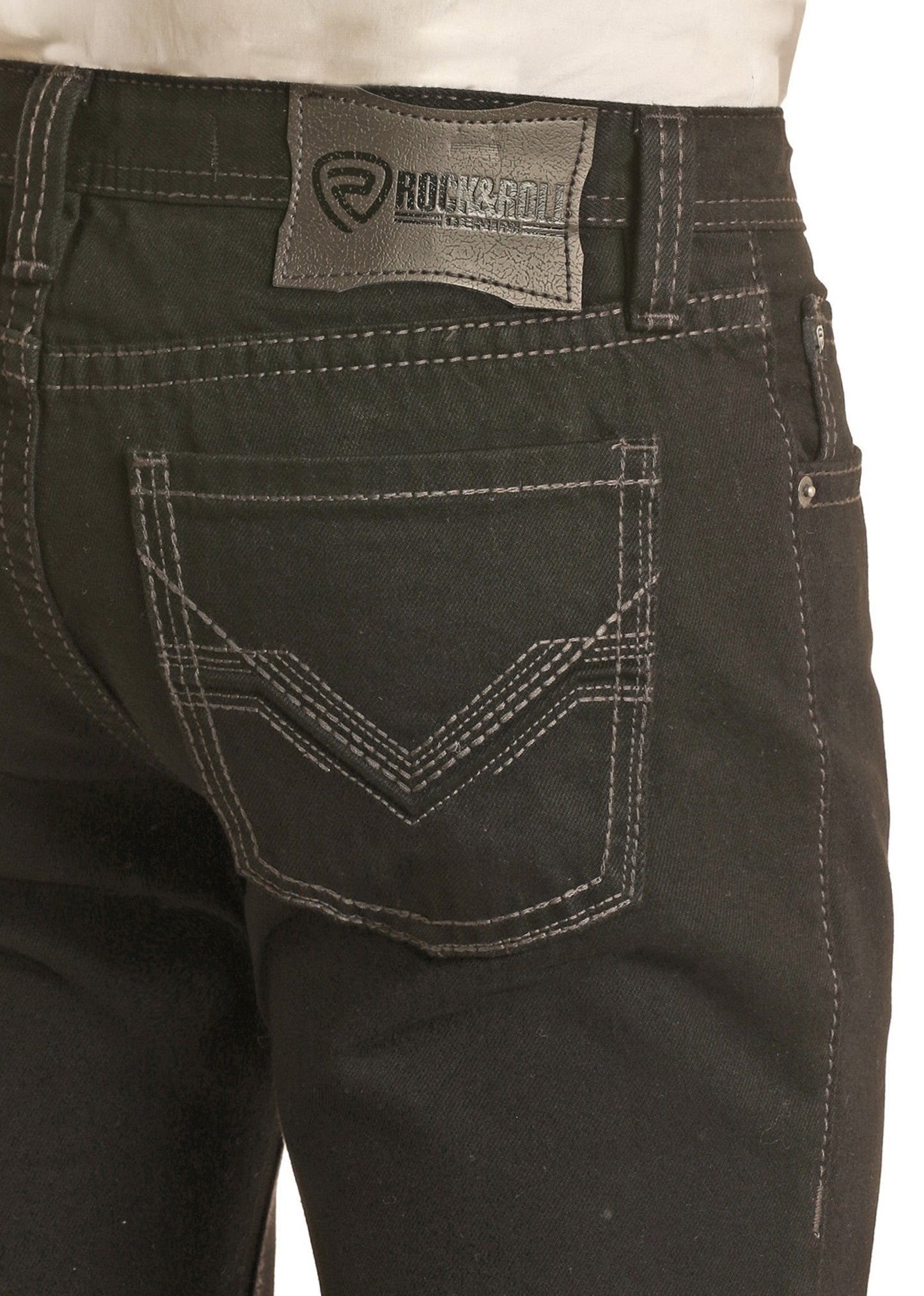 Someone is seen from the back wearing Rock & Roll Denim Black Slim Straight Jeans with white stitching and a gray brand label on the waistband.