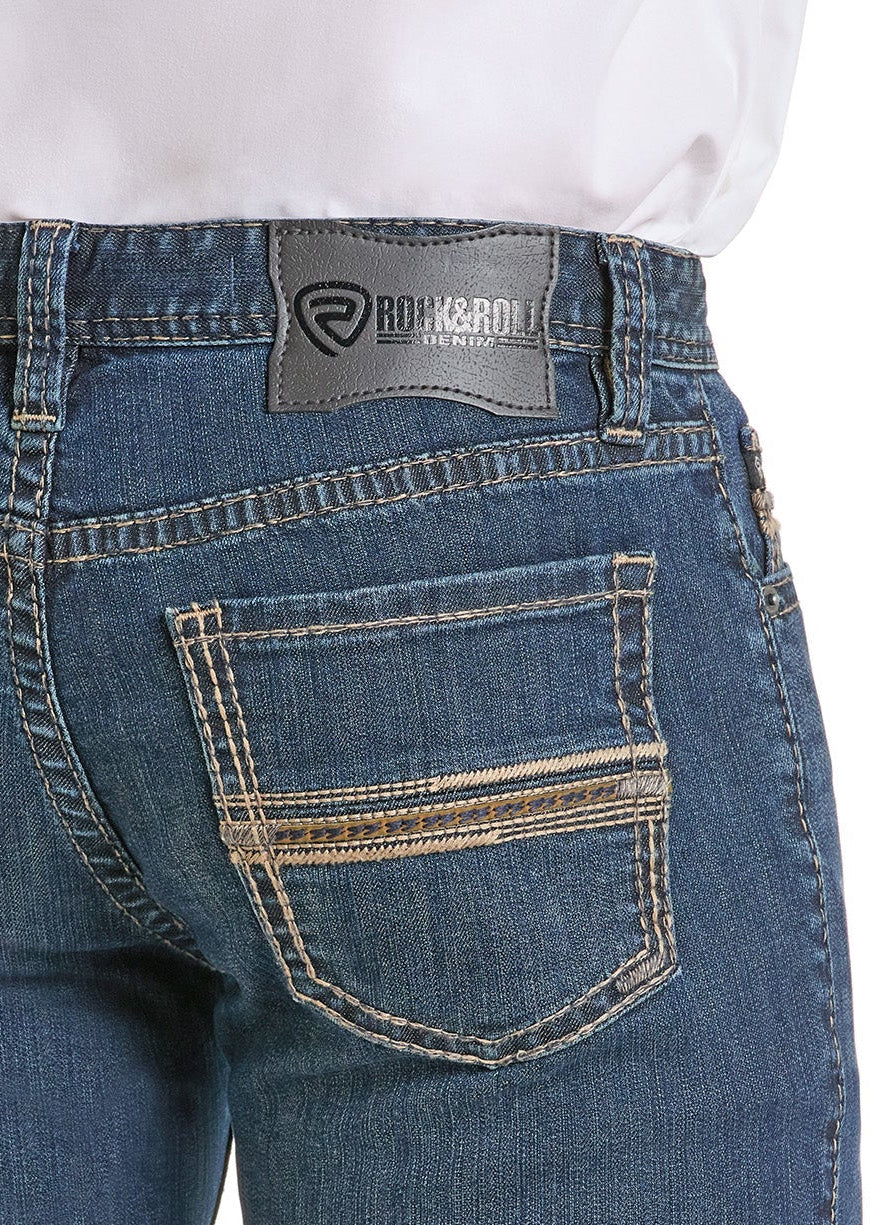 A person wearing Rock & Roll Denim Slim Fit Embroidered Pocket Straight Leg Jeans with white contrast stitching, two back pockets, and a gray brand patch on the waistband, shown from the waist down.