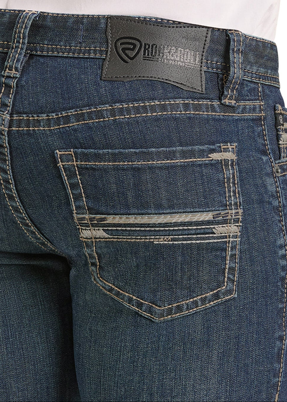 Close-up of the back of blue Slim Fit Pleather Pocket Stitch Straight Leg Jeans by Rock & Roll Denim, featuring contrast stitching, a pleather-detailed back pocket, and a black leather logo label on the waistband.
