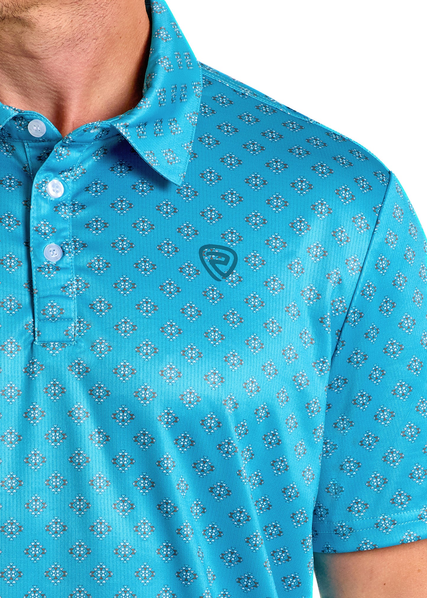 A close-up shows a person wearing the Rock & Roll Denim Peacock Blue Aztec Polo, featuring a bright blue diamond pattern, white buttons, and a small chest logo. Only part of their face and upper body is visible.