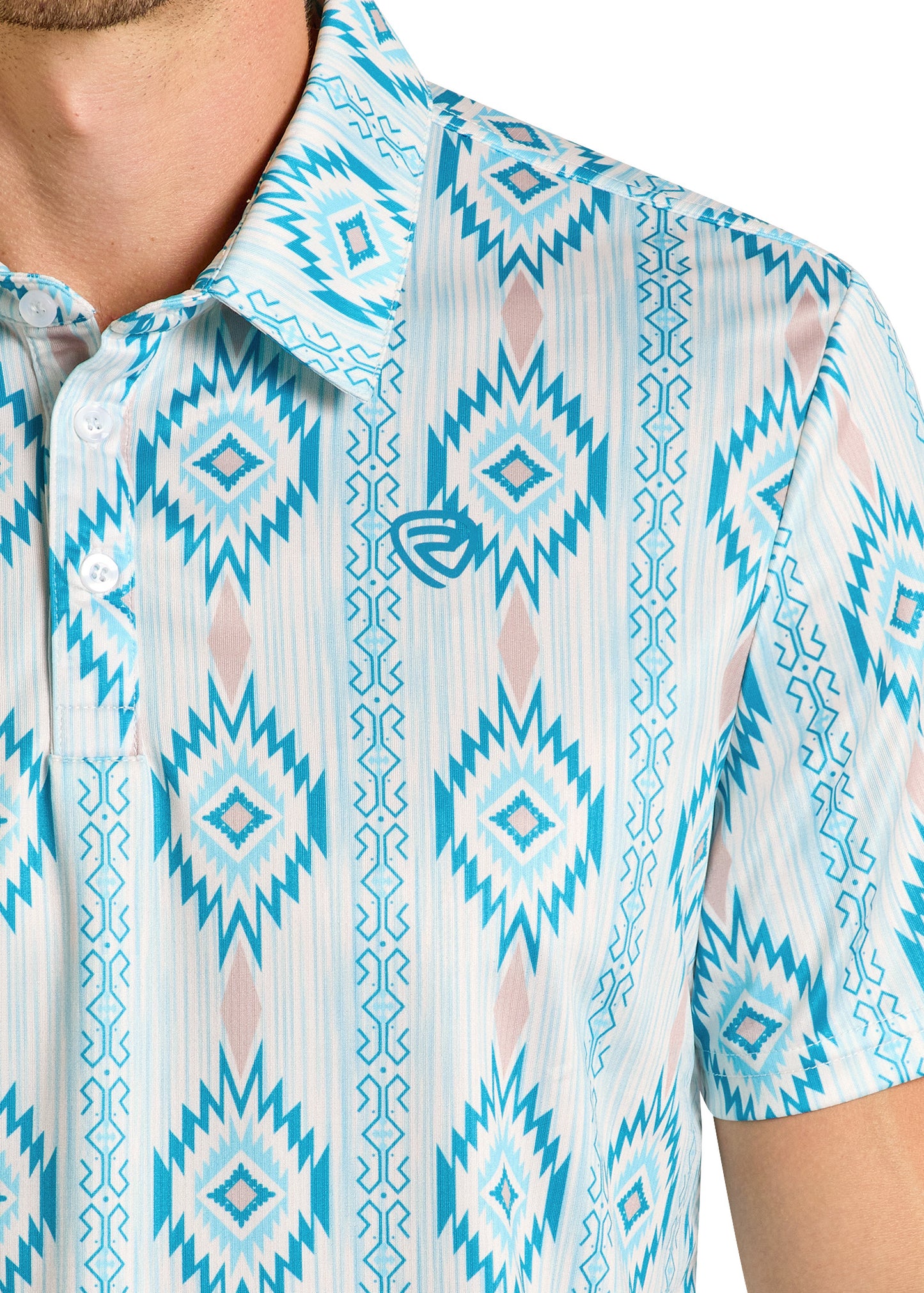 A person in a Rock & Roll Denim Caribbean Aztec Polo, a blue and white geometric patterned, regular fit short-sleeve shirt with an embroidered chest logo. Only the upper torso and part of the face are visible.