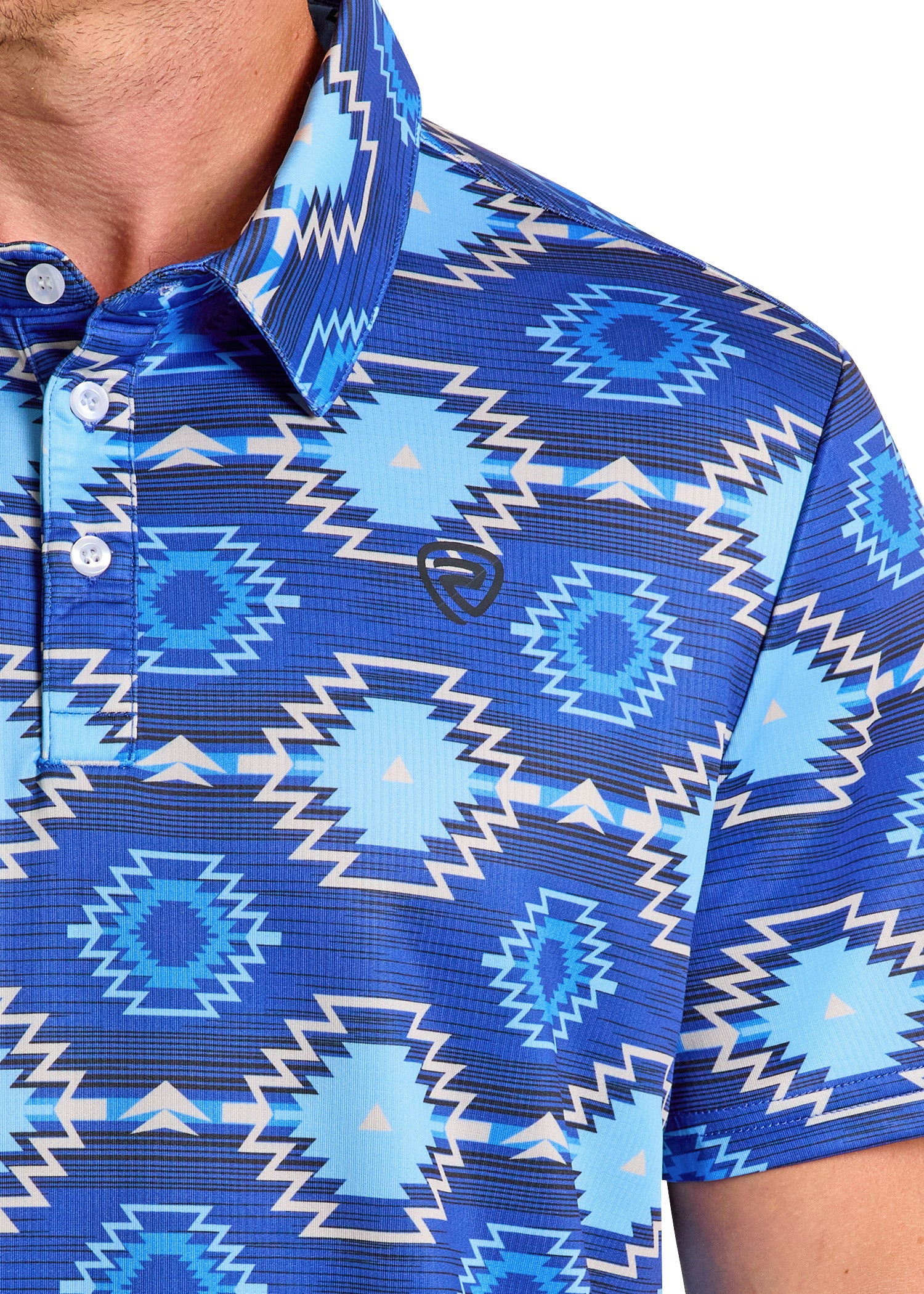 A close-up of a person wearing the Rock & Roll Denim Bold Blue Aztec Polo, featuring geometric patterns in blue and white, a small embroidered logo, and a southwestern-inspired polyester-spandex casual design.