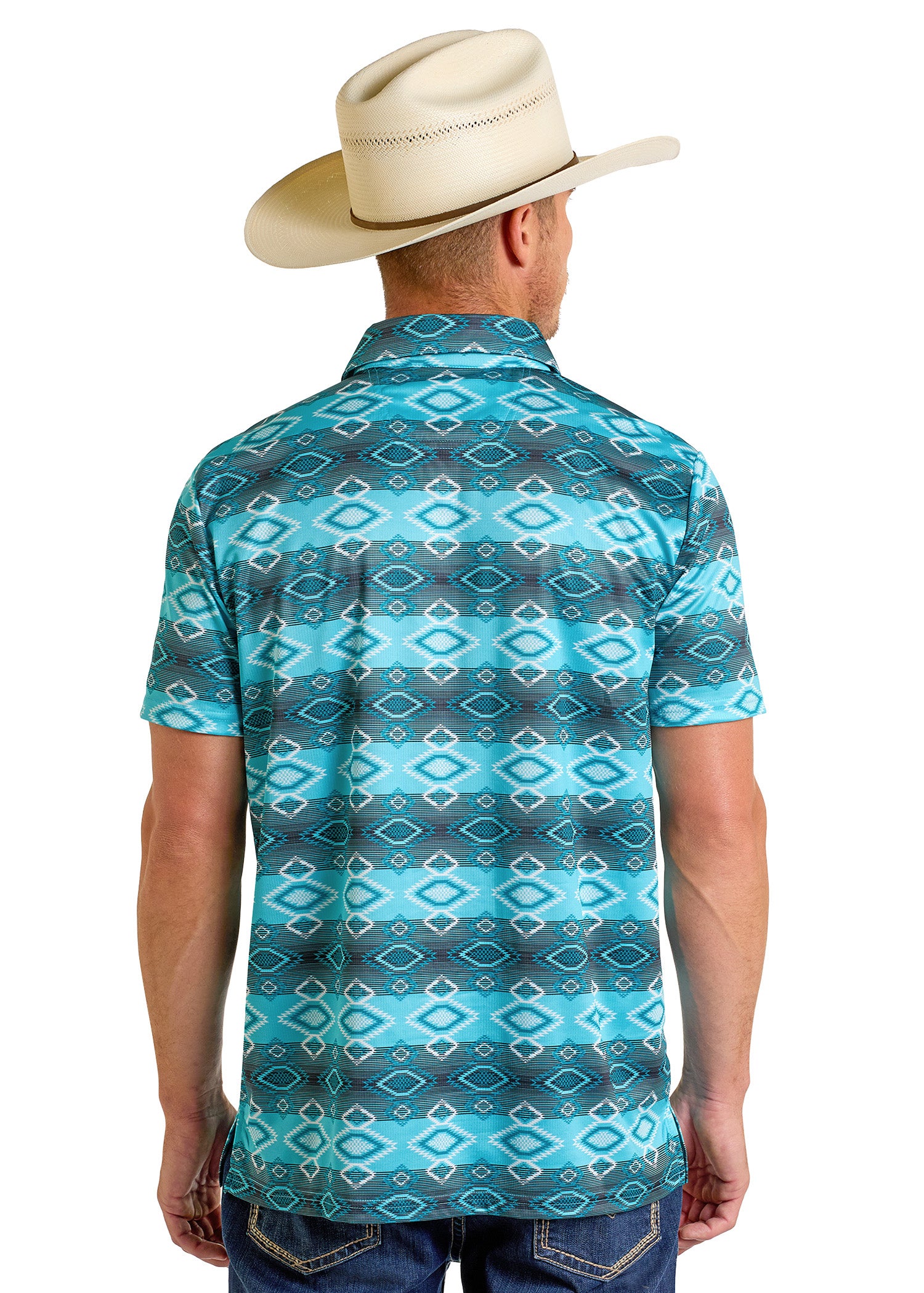A man wearing a cream cowboy hat and a Rock & Roll Denim Aztec Vertical Striped Polo is standing with his back to the camera. He is also wearing blue jeans.