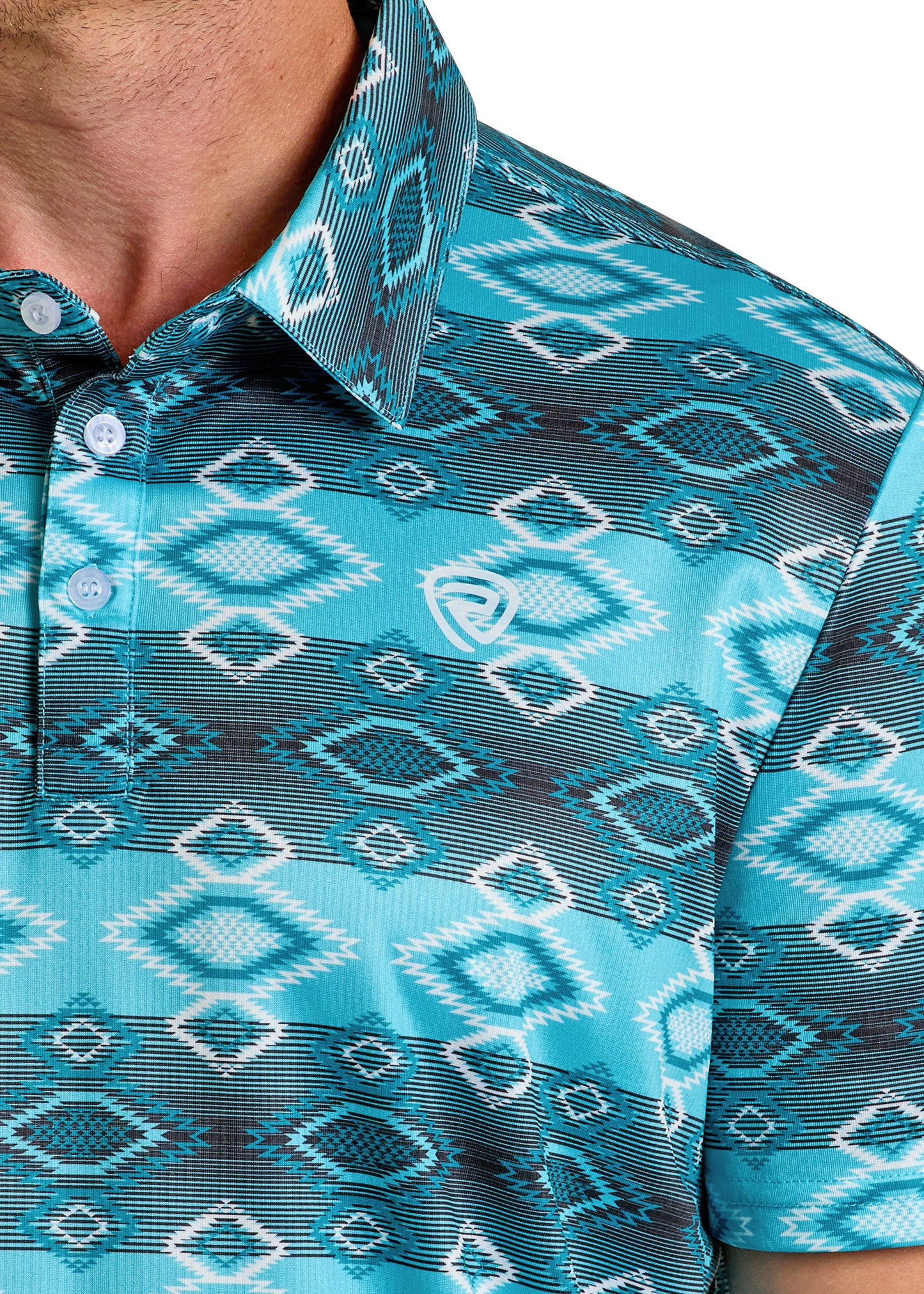 Close-up of a person in the Rock & Roll Denim Aztec Vertical Striped Polo, featuring teal, blue, and white bold geometric patterns, a collar with buttons, and a small white chest logo. The casual shot partially crops the face for style.