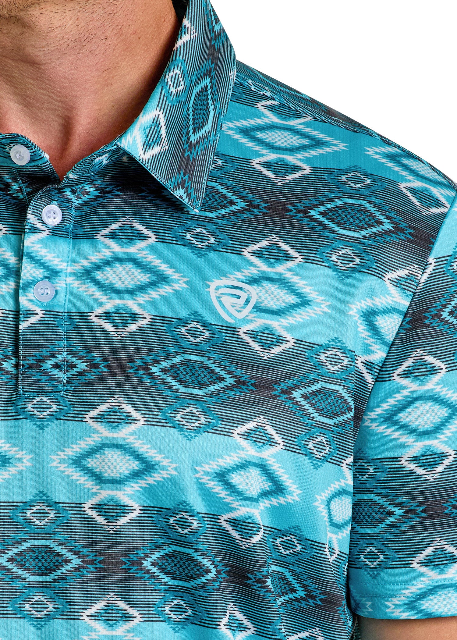 Close-up of a person in the Rock & Roll Denim Aztec Vertical Striped Polo, featuring teal, blue, and white bold geometric patterns, a collar with buttons, and a small white chest logo. The casual shot partially crops the face for style.