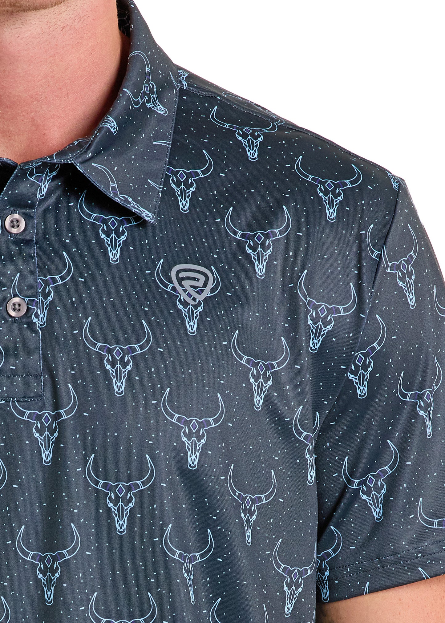 Close-up of a person in the Rock & Roll Denim Longhorn Skulls Polo - S, a dark regular fit casual shirt featuring blue outlined Longhorn Skulls and small white dots; part of the face and torso is shown.