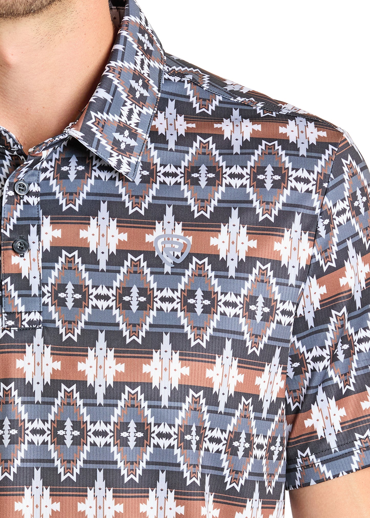 A close-up of a person wearing the Rock & Roll Denim Black & Brown Aztec Polo, a regular fit, short-sleeve button-up with a geometric pattern. Only the upper torso and part of the left arm are visible.