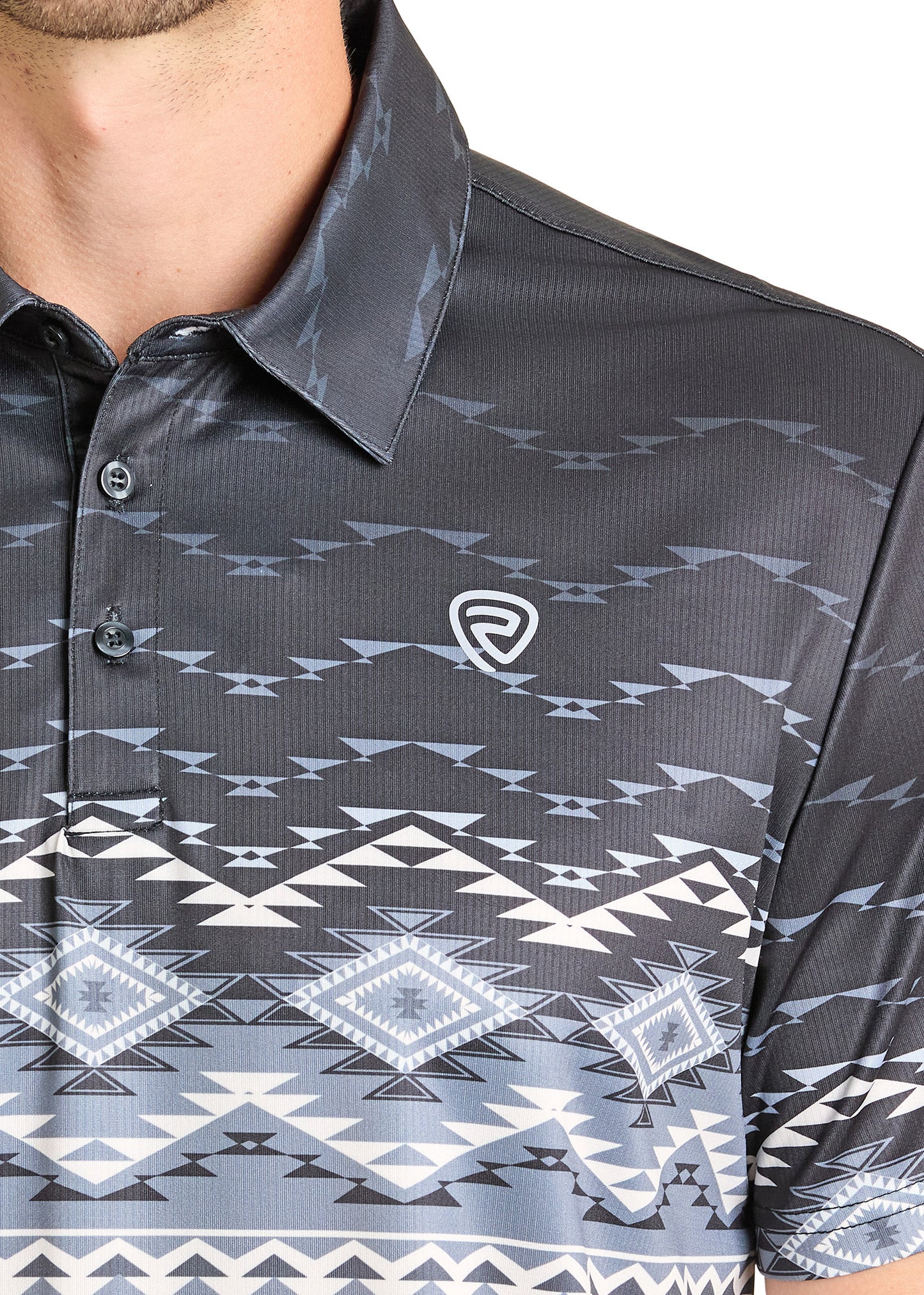 A close-up of a person in the Rock & Roll Denim Black & White Aztec Polo, a casual regular-fit shirt with geometric patterns and a chest logo. The person's face is partially out of frame.