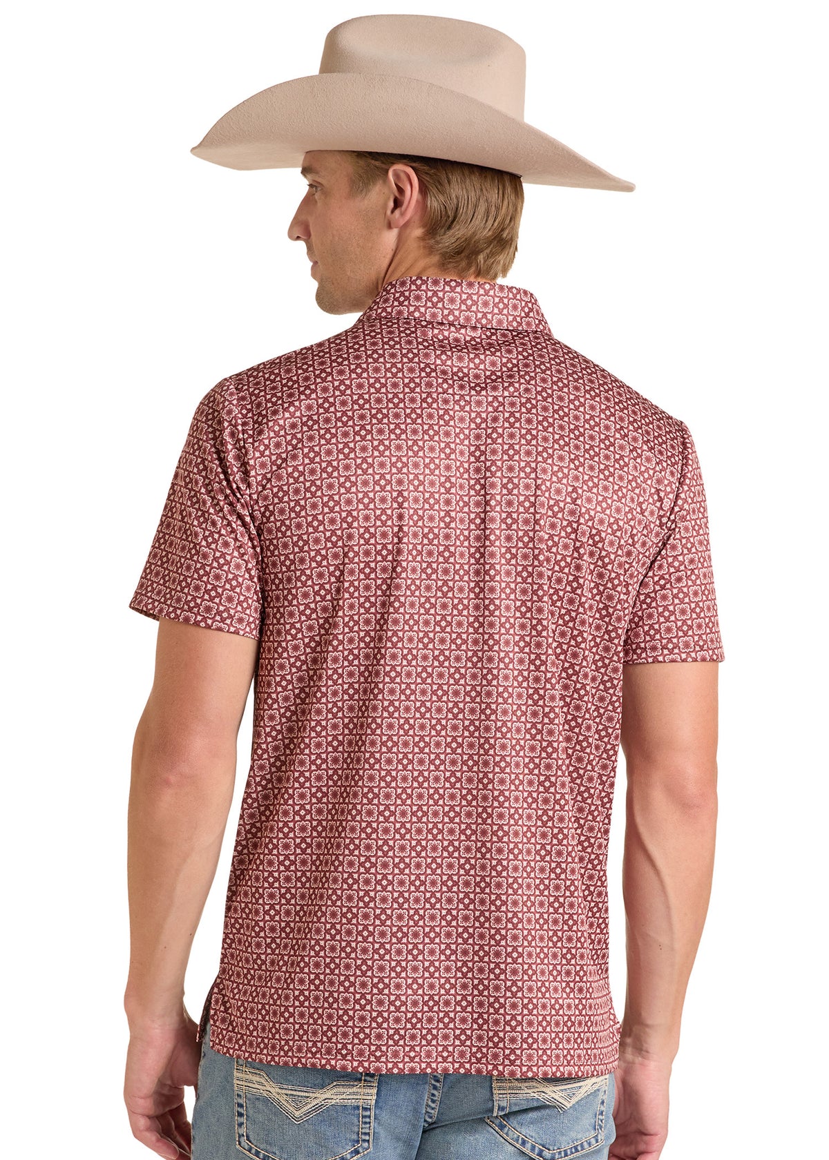 A man wearing a light beige cowboy hat and a short-sleeve collared shirt with a small repeating geometric pattern in pink and white, shown from the back against a plain white background.