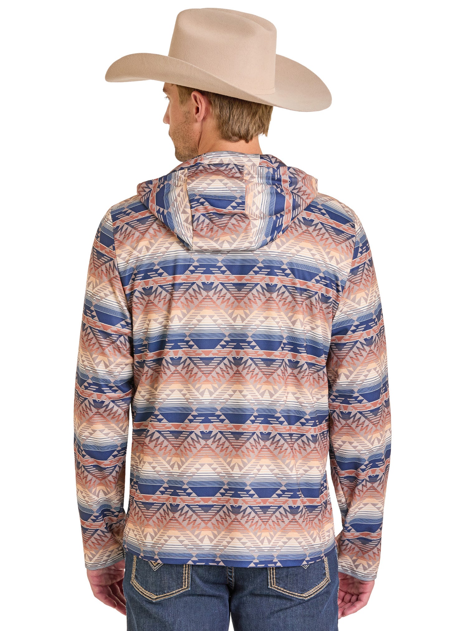 A man in a beige cowboy hat and Rock & Roll Denim’s Aztec Stripe Performance Hoodie, featuring a blue, brown, and white geometric pattern, stands with his back turned, wearing comfortable blue jeans.