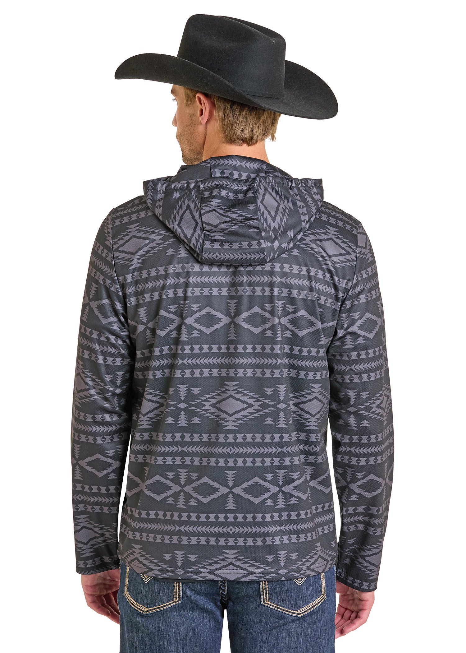 A man wearing a black cowboy hat, blue jeans, and a Rock & Roll Denim Black Aztec Performance Hoodie with a gray and black geometric pattern is shown from the back.