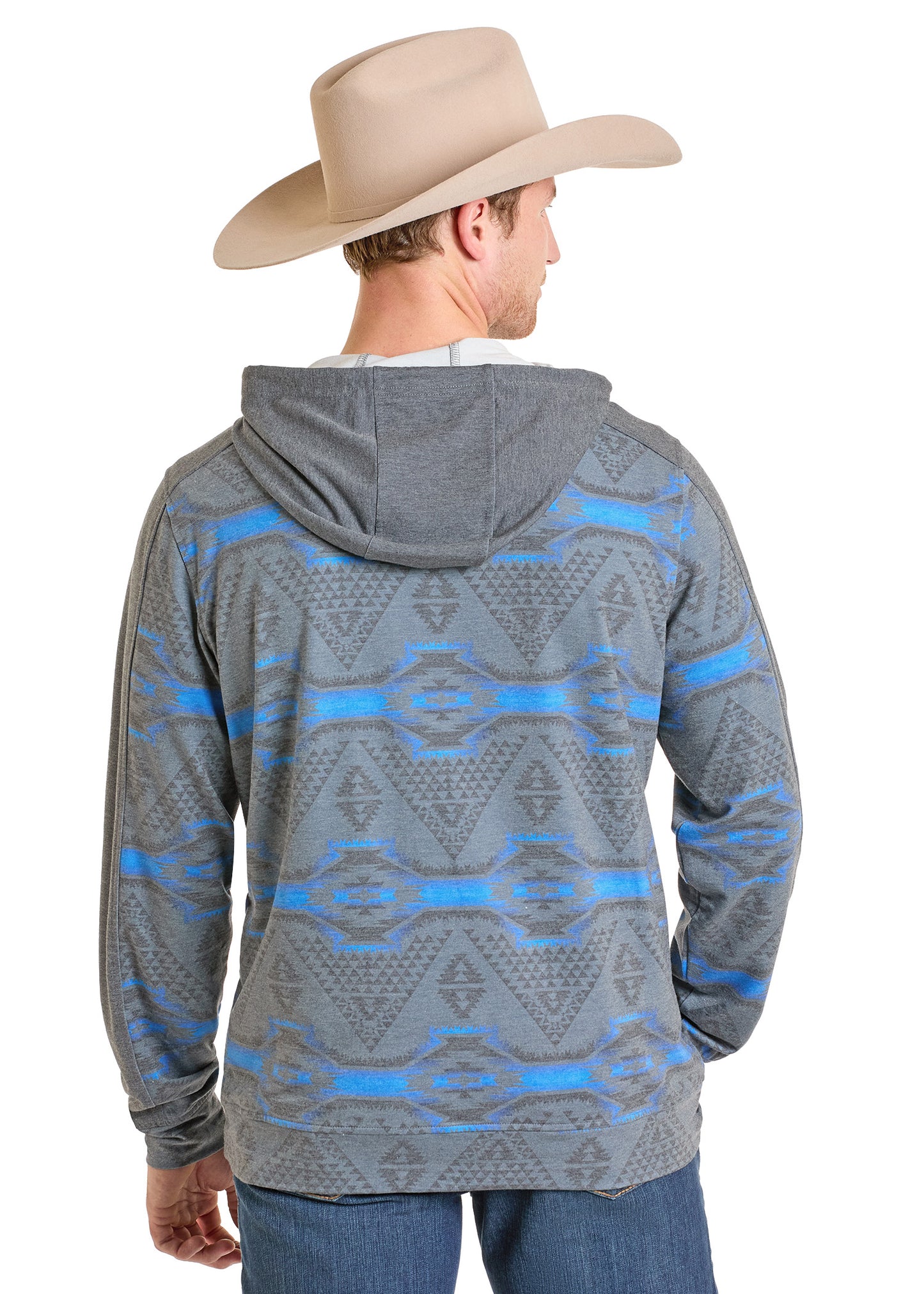 A man in a tan cowboy hat wears a Rock & Roll Denim Grey Aztec Performance Hoodie with blue jeans, standing with his back to the camera, highlighting the hoodie’s comfortable fit and geometric pattern.