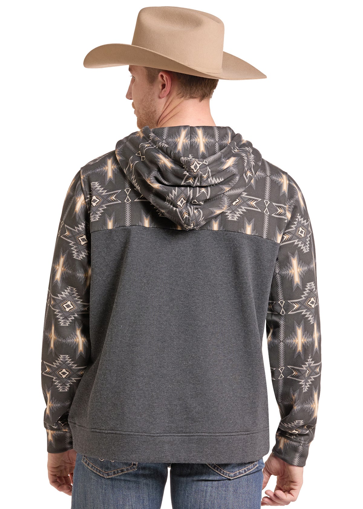 A man wearing a dark gray hoodie with a beige and white Southwestern pattern on the sleeves and hood, shown from the back. He is also wearing a tan cowboy hat and blue jeans against a plain white background.