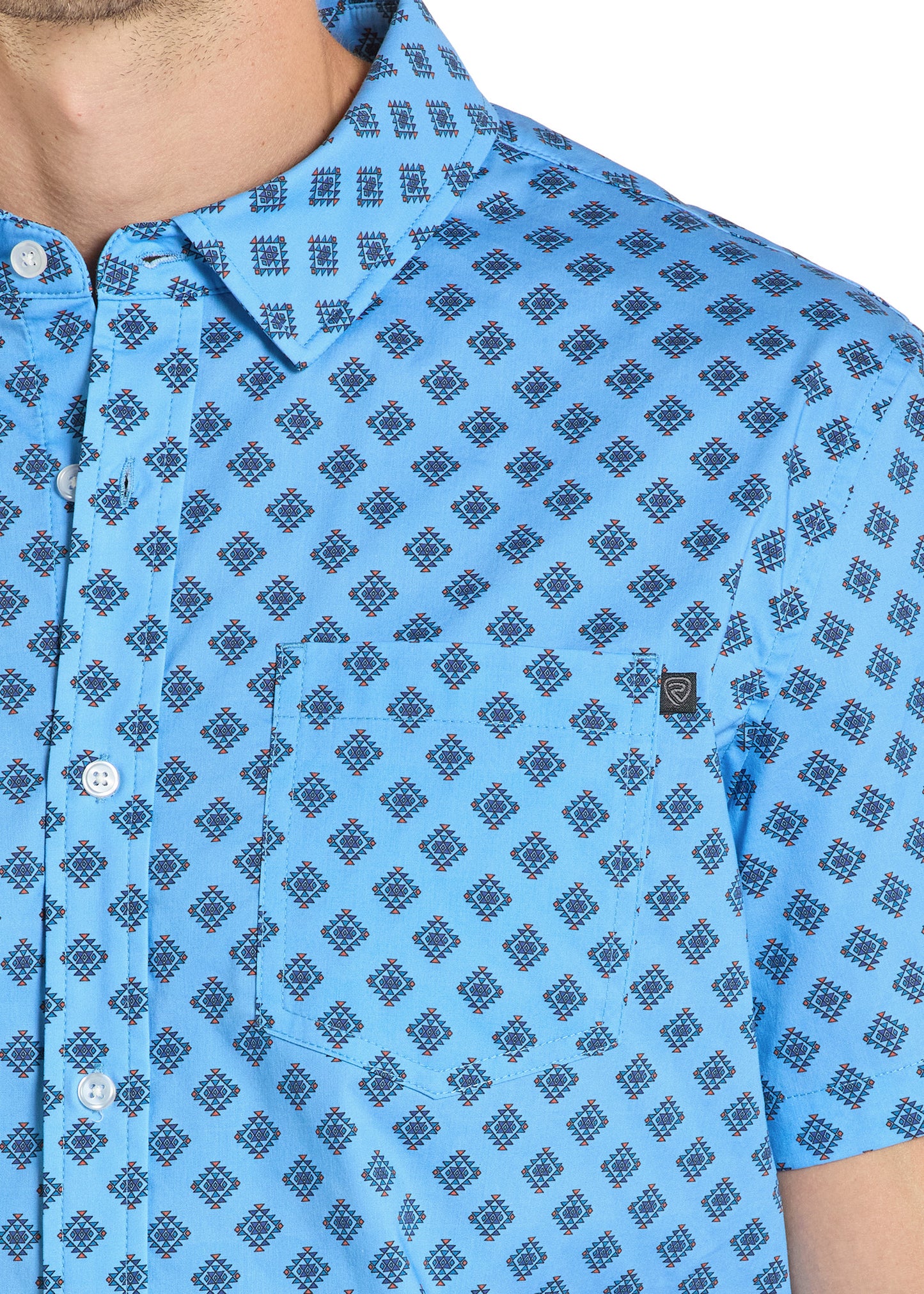 Blue patterned shirt worn by a person, close-up view.