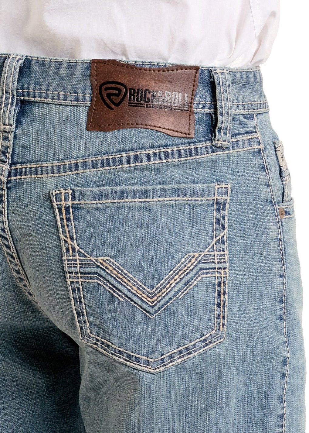 A close-up of the back of a person wearing Rock & Roll Denim High Rise Alpha Relaxed Fit Tapered Bootcut Jeans in light blue, featuring white stitching, two back pockets, and a brown leather brand patch on the waistband.