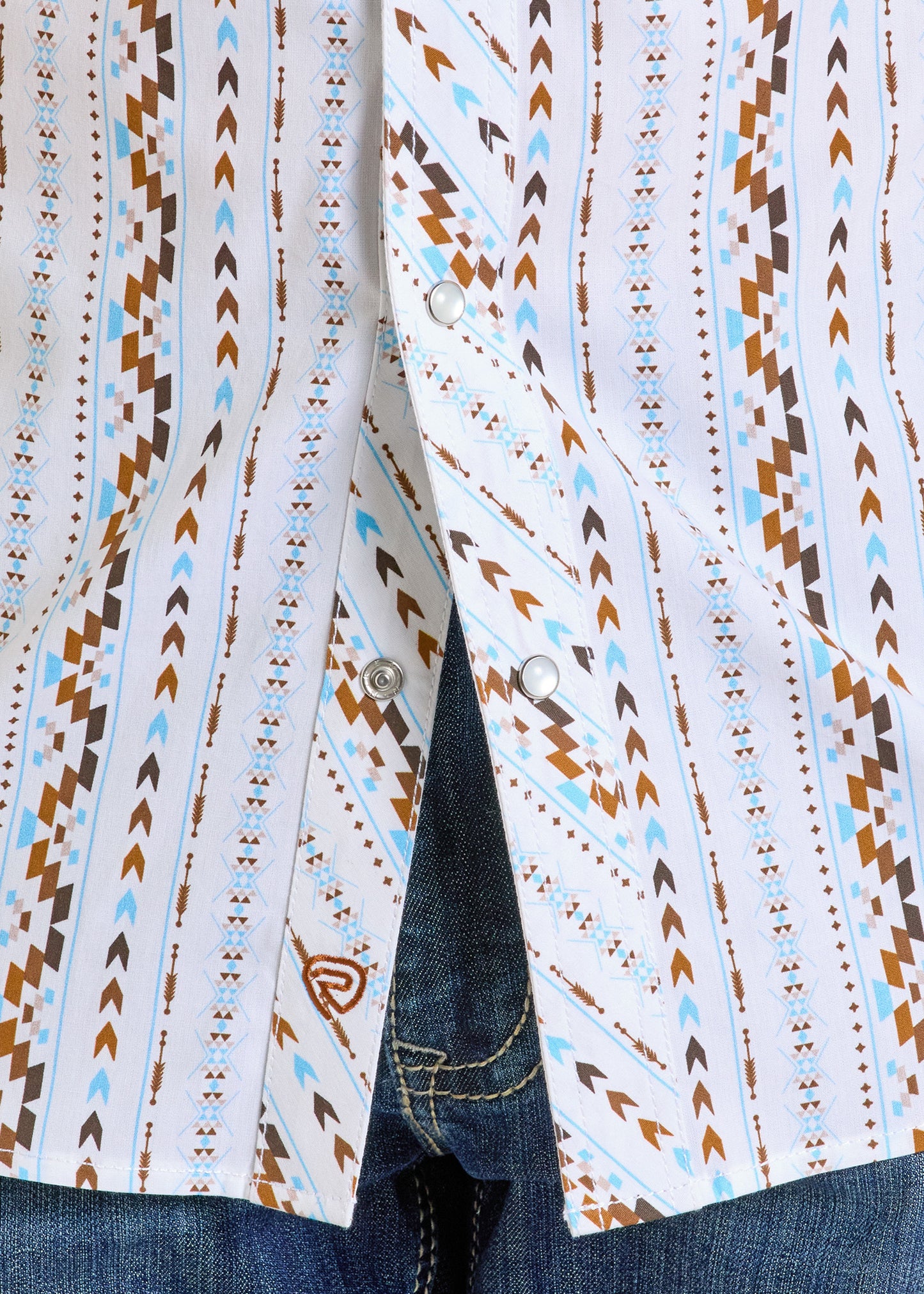 A close-up of the Rock & Roll Denim Slim Fit Digital Aztec Long Sleeve Snap Shirt, featuring a white snap front and geometric brown, blue, and tan southwestern pattern, styled with blue jeans.