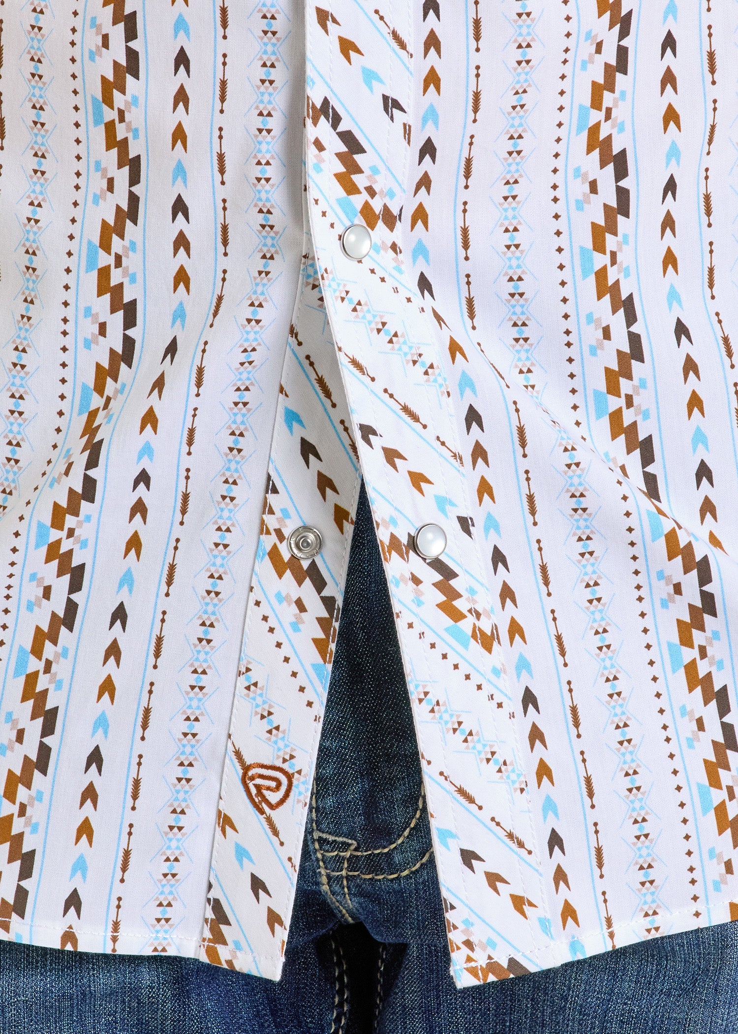 A close-up of the Rock & Roll Denim Slim Fit Digital Aztec Long Sleeve Snap Shirt, featuring a white snap front and geometric brown, blue, and tan southwestern pattern, styled with blue jeans.