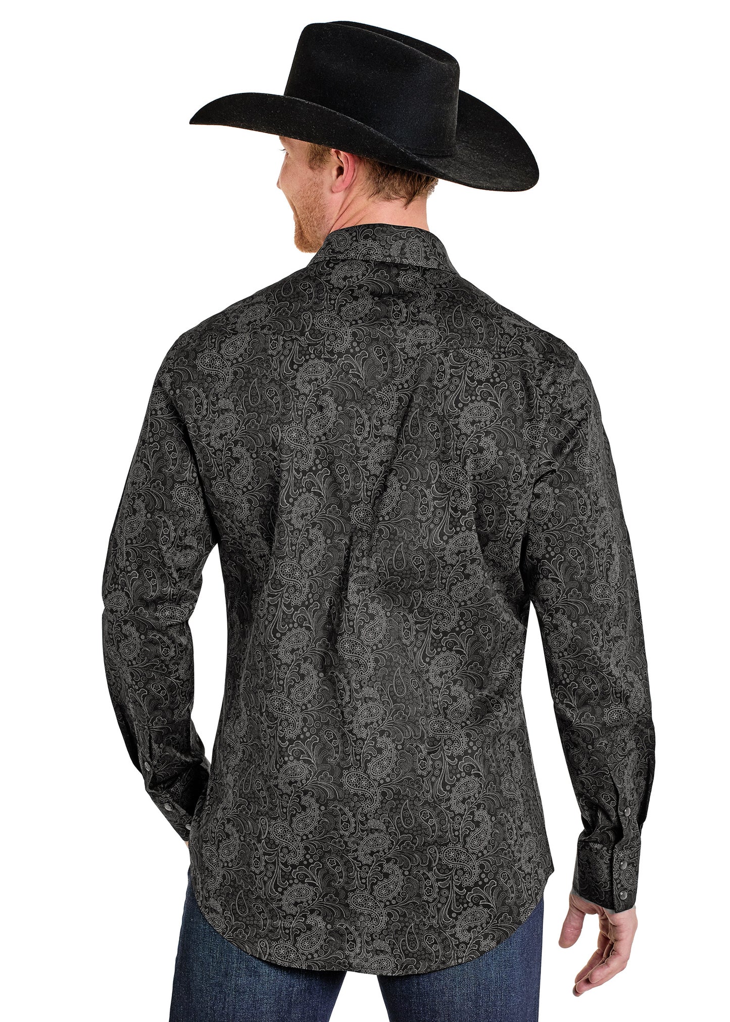 Man wearing a black cowboy hat and patterned shirt on a white background