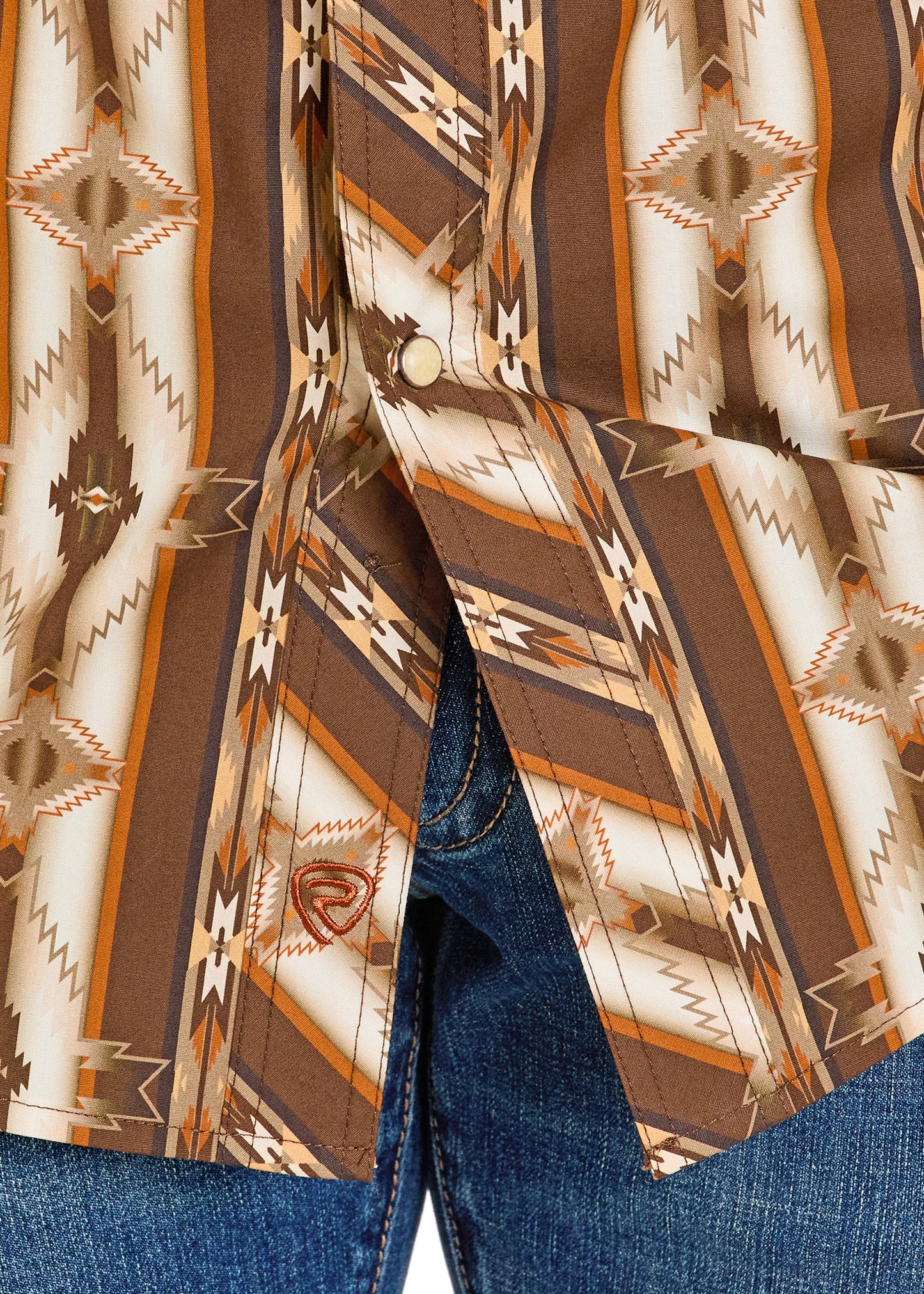 Close-up of a patterned shirt with a geometric design on a blue denim background