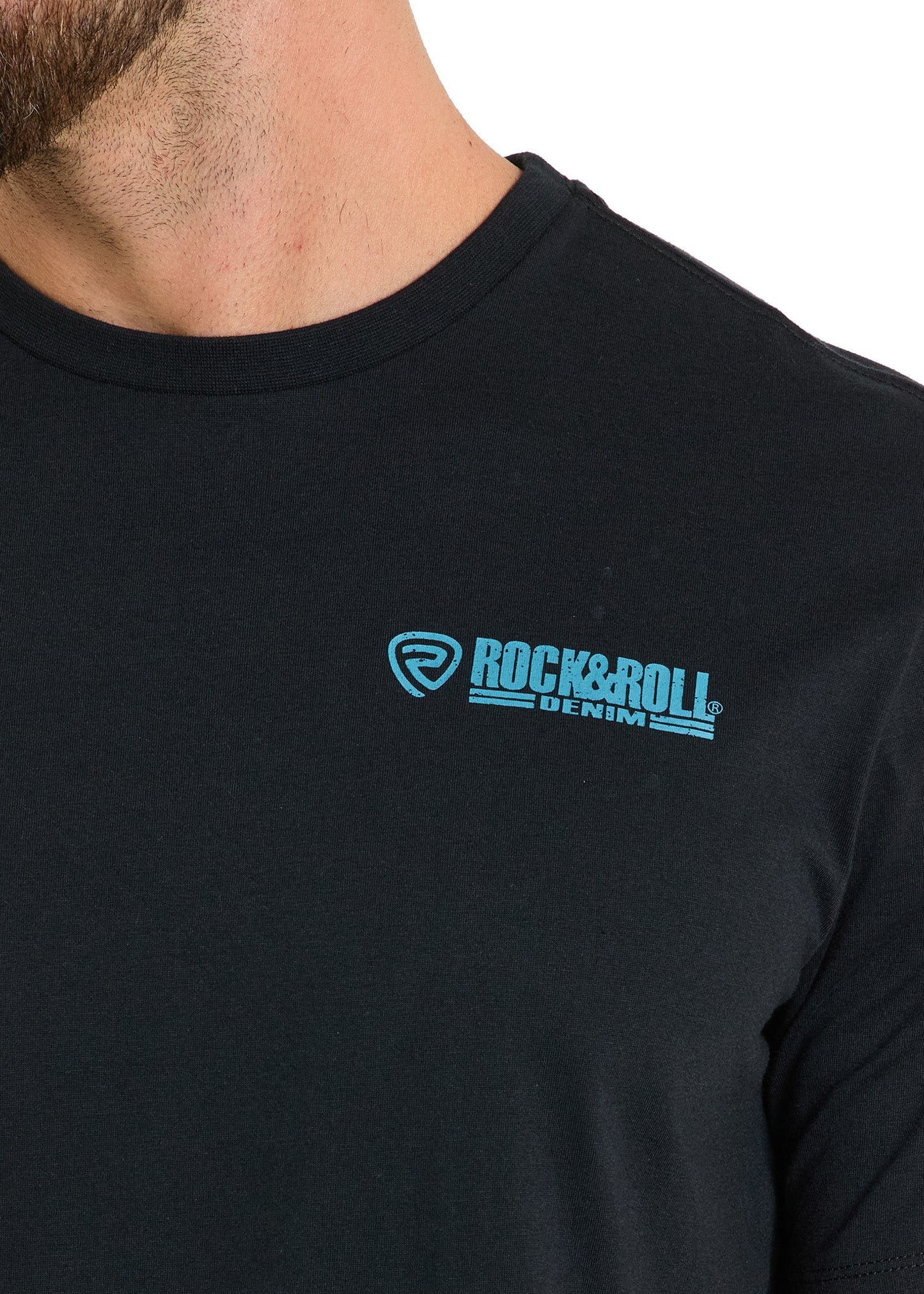 Close-up of a person wearing the Bull Skeleton Unisex Graphic Tee by Rock & Roll Denim, featuring a black design with a blue logo on the left chest. The wearer’s face is partially out of frame.