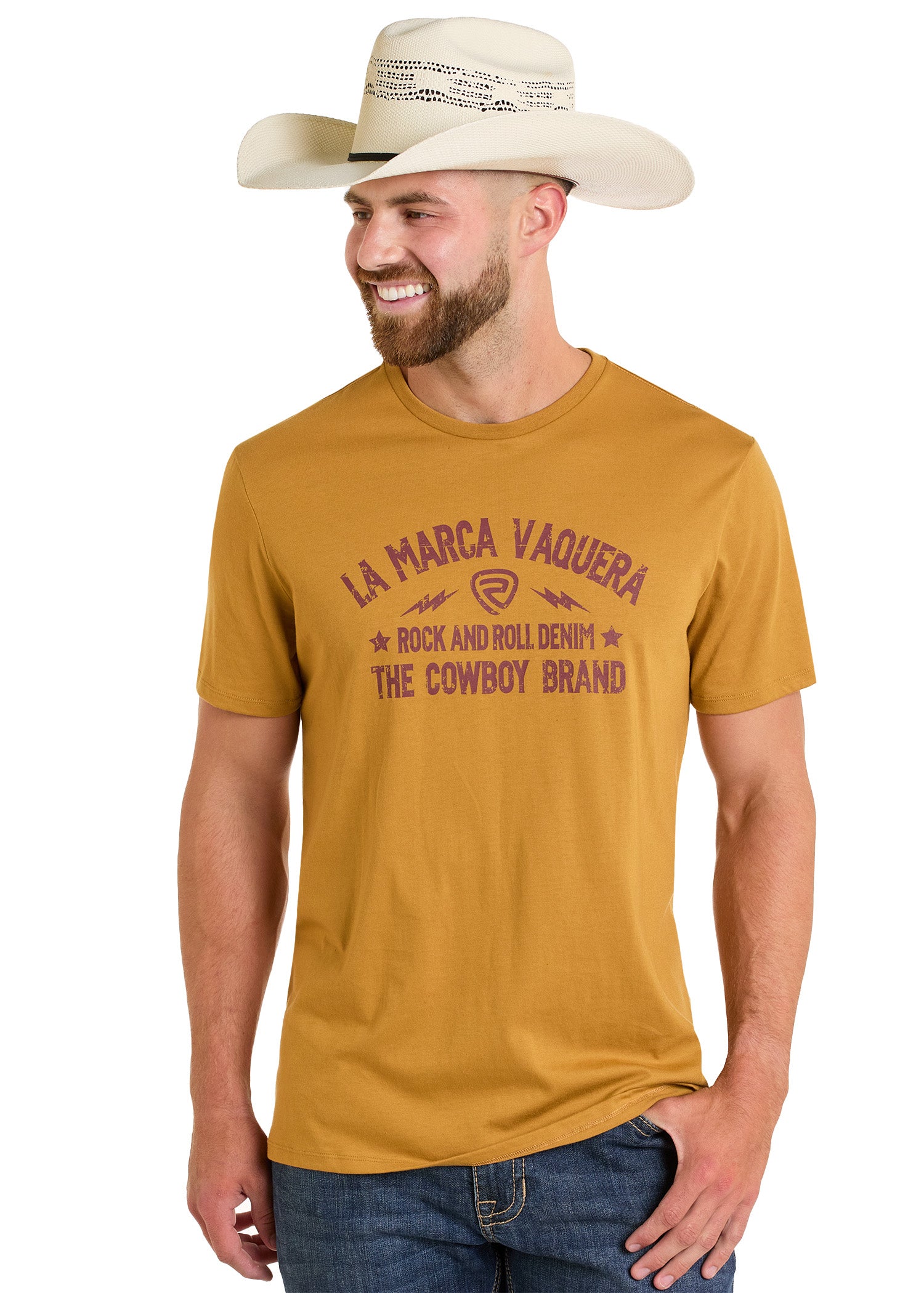 A man in a tan cowboy hat and the La Marca Vaquero Graphic Tee by Rock & Roll Denim smiles with one hand in his pocket, showing off this comfortable t-shirt.