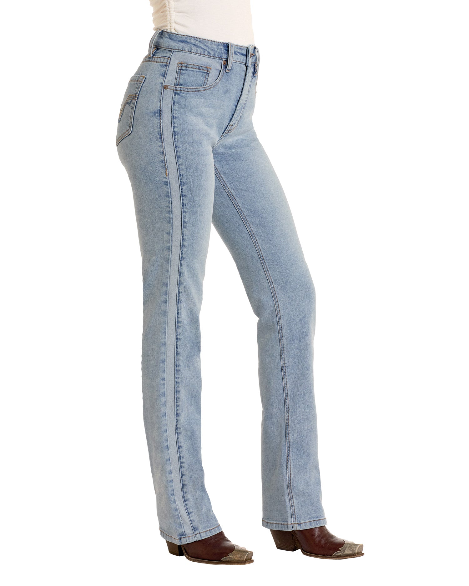 A person in light blue Two-Tone Modest Bootcut Jeans by Rock & Roll Denim, a white top, and brown pointed-toe boots stands sideways, highlighting the jeans’ side profile.